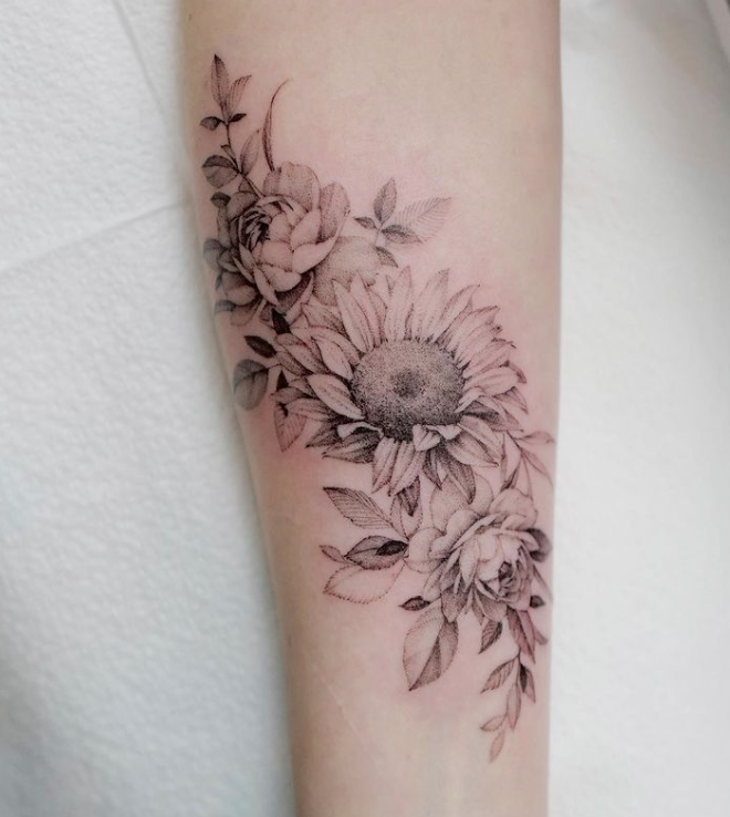 Fine line flower tattoo on the wrist.