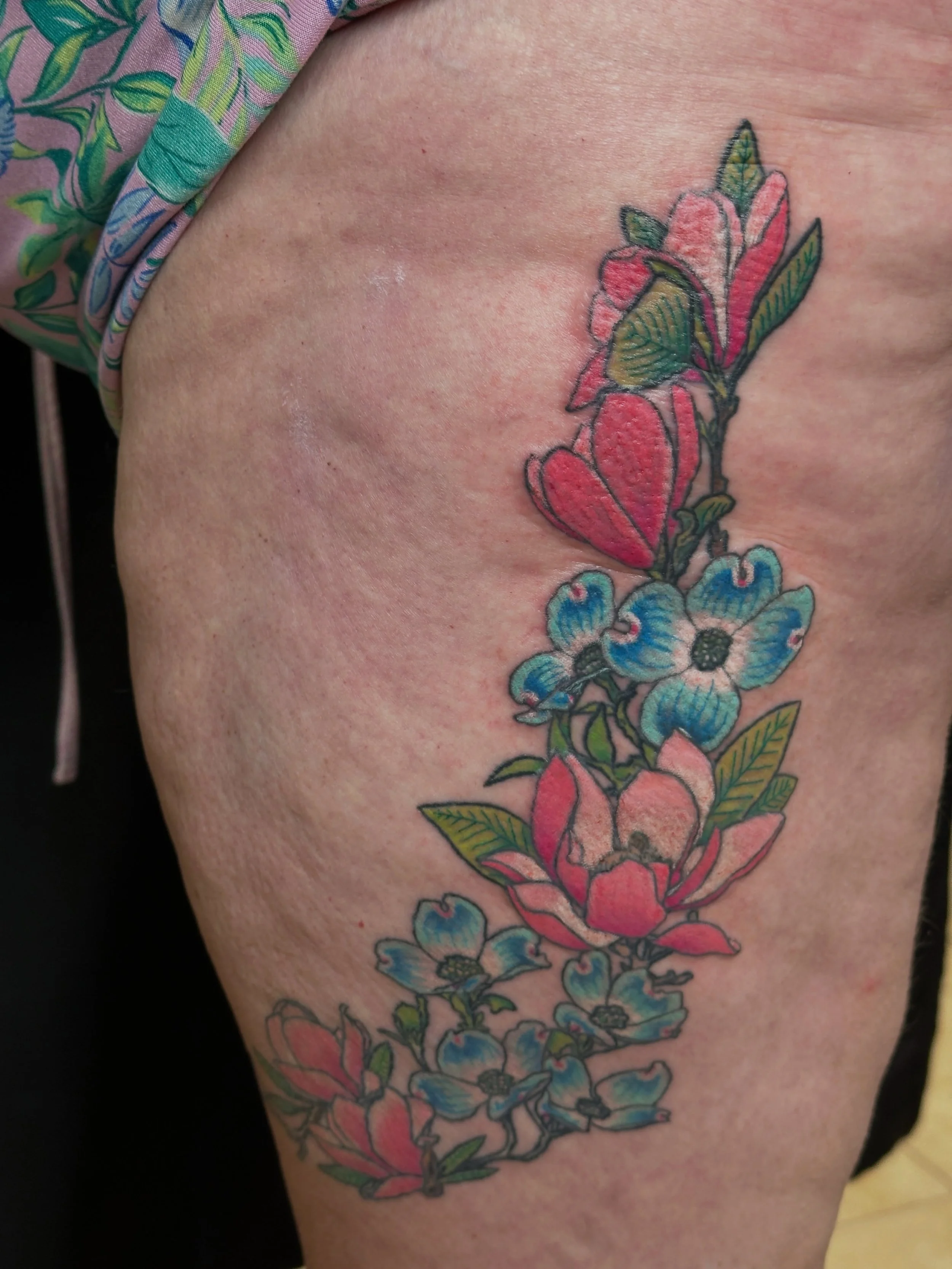 Adding color to a floral thigh tattoo. Caroline loves doing large pieces as much as she loves the small ones #radiantenergytattoobricknj #femaletattooer #floraltattoos #thightattoo #thightattoosforwomen