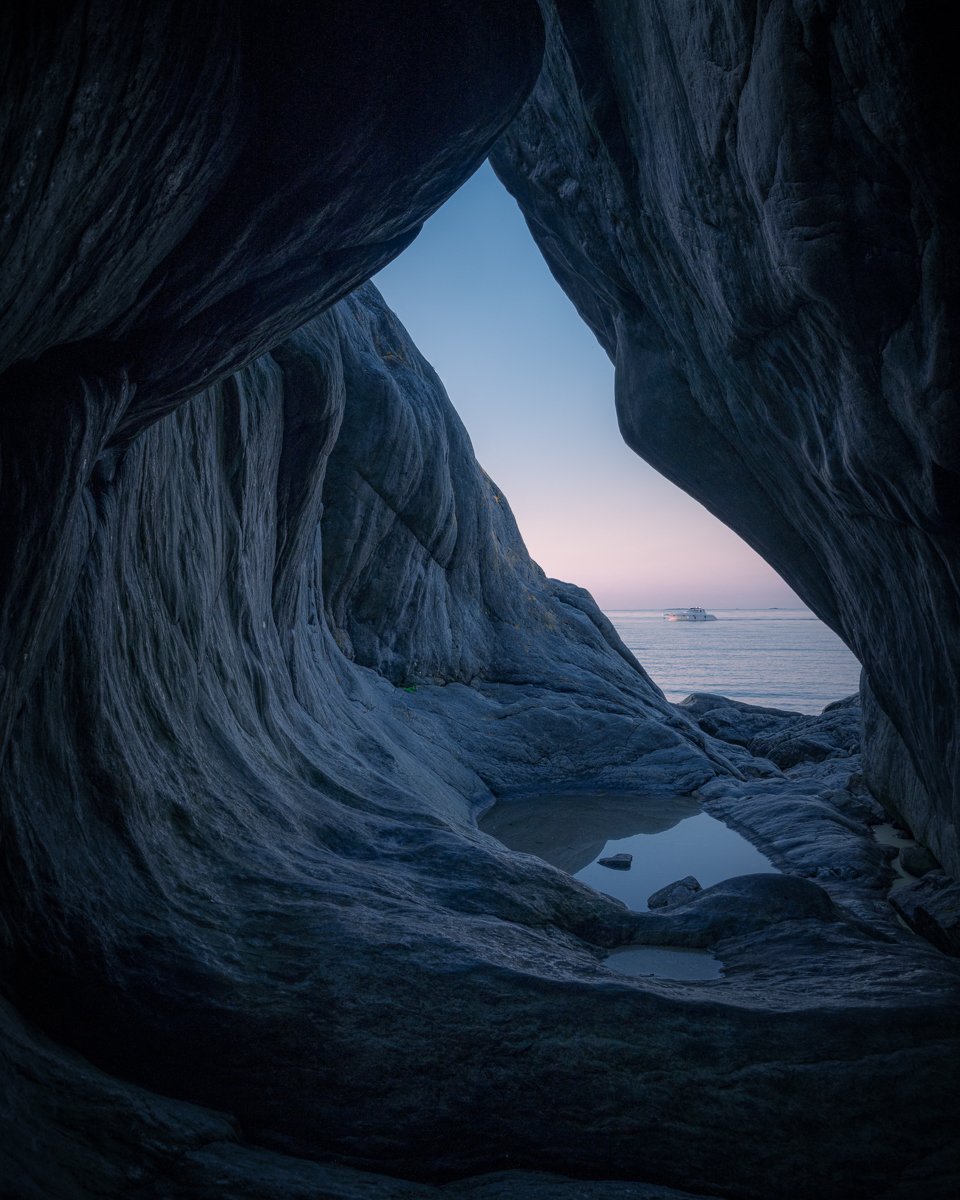 Airpixels' Tobias Hägg has captured the mesmerizing beauty of Knappelskär's caves with this stunning landscape photograph. The image showcases the intricate details of the caves and the serene atmosphere inside, with the warm hues of the sunrise addi