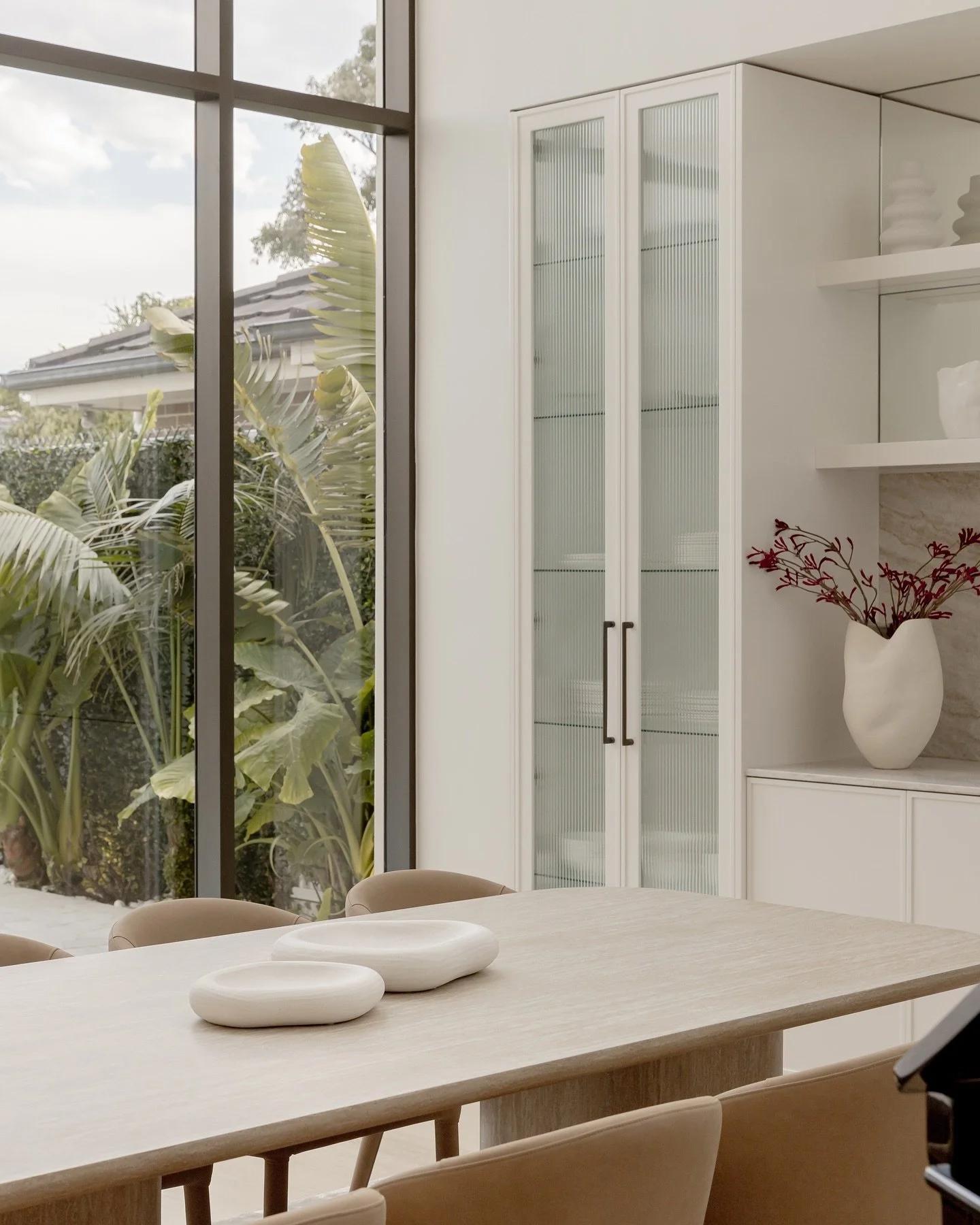 With a void and full height windows, this beautiful dining space has a serene view over the pool and lush greenery outside. Our team have opted to keep our styling quite simple on the dining table so the view could take center stage 🤍 

&bull;

&bul