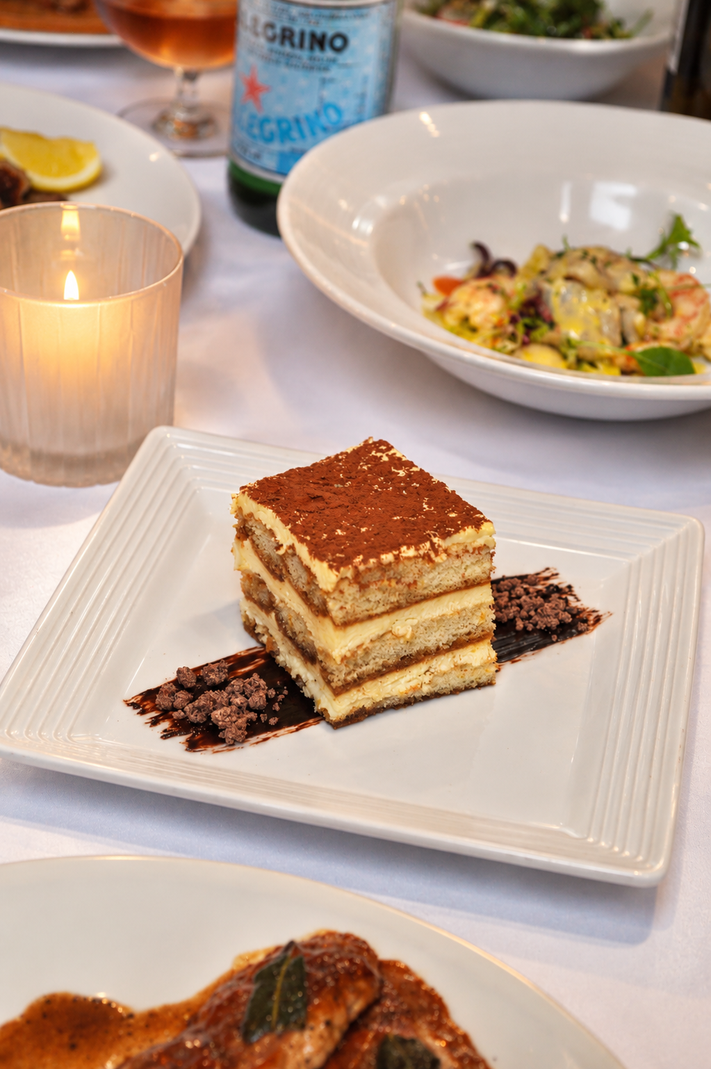 Cocoa-Dusted Tiramisu at Candlelit Table.png