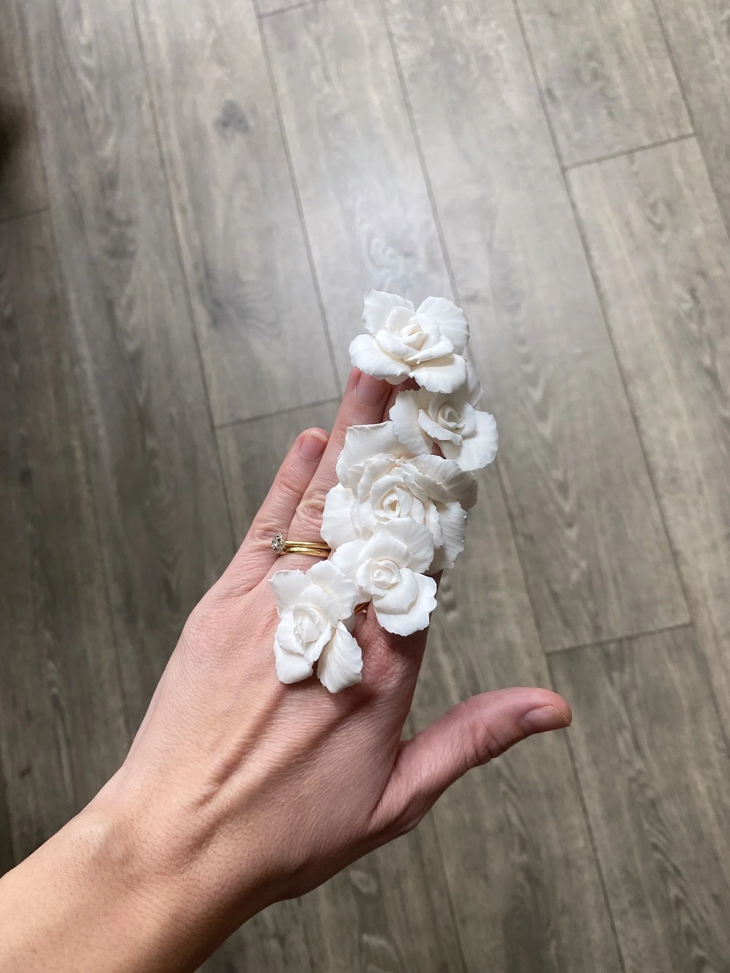 Most of my designs start with a flower rather than a sketch. I make and adjust until it feels balanced — not too polished, not too precious. I keep a record of trial pieces with a photograph, usually just for myself (which is why my feet often