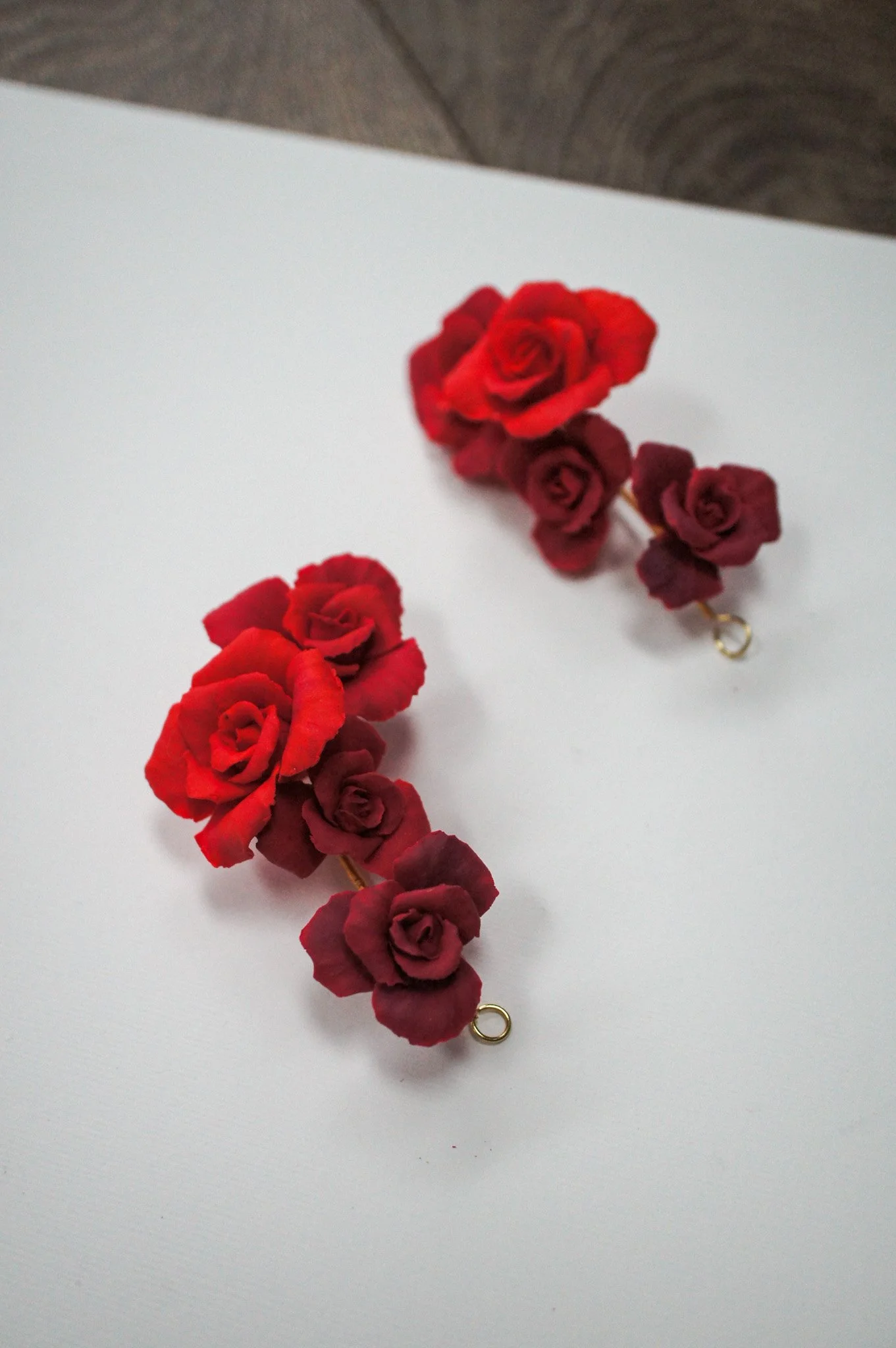 Two red rose bridal hairpieces, versatile styling for updos, side placement, or together for romantic wedding hairstyles.