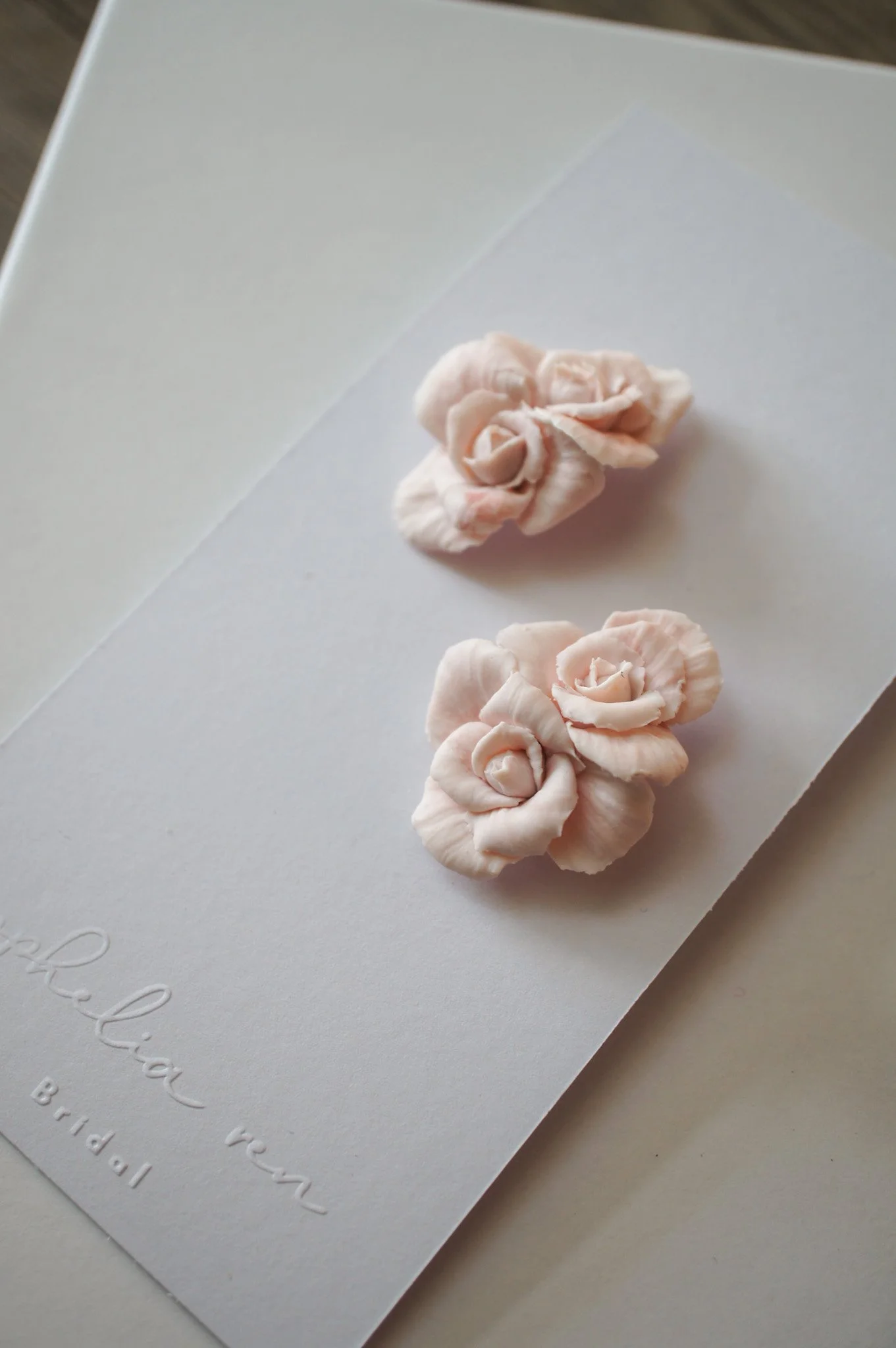 Rose stud earrings in white or pale pink