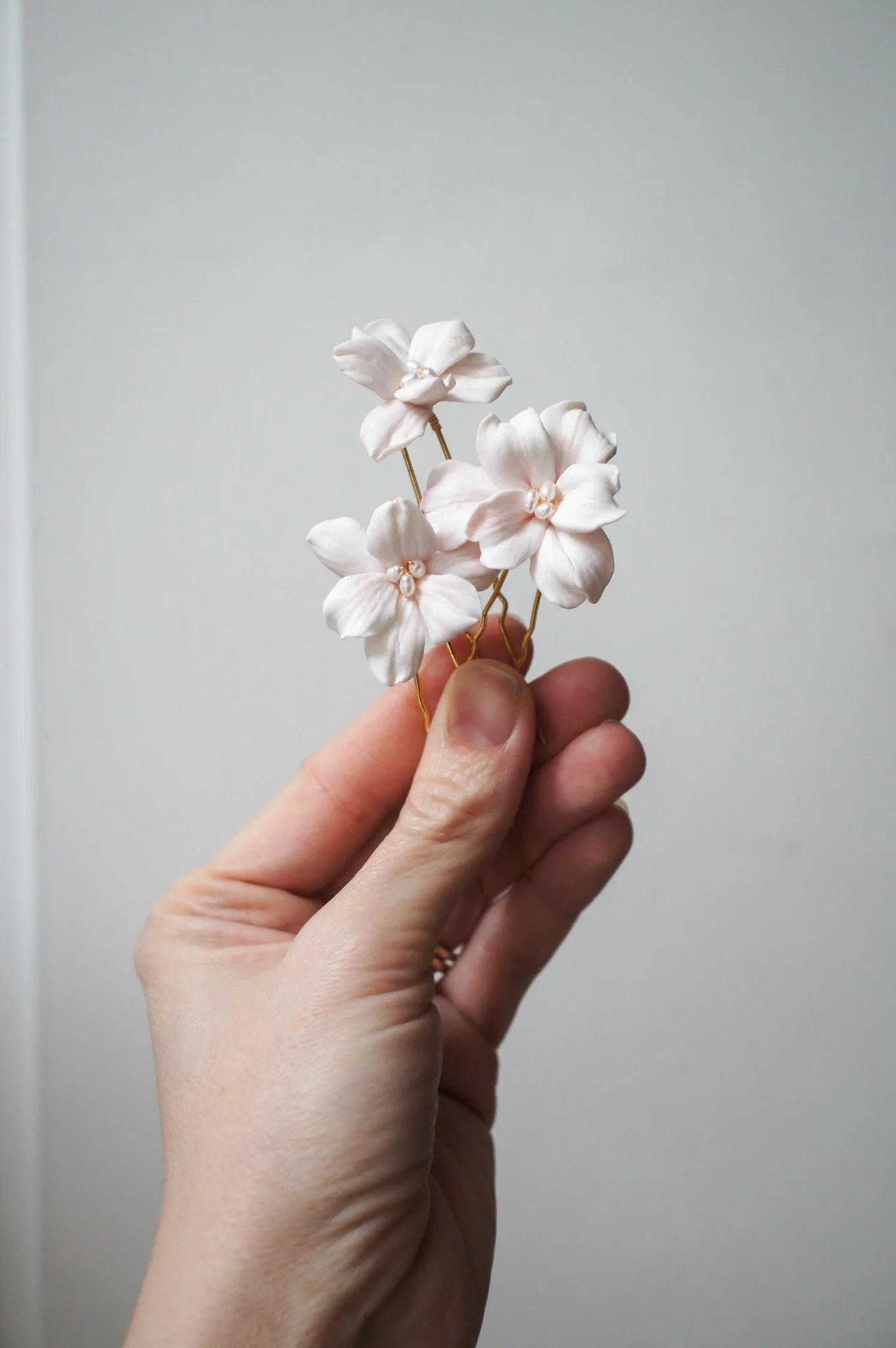 Seren hairpin set of three with delicate blush pink six-petal flowers. Elegant floral bridal hair pins for weddings, bridesmaids, and gifting.