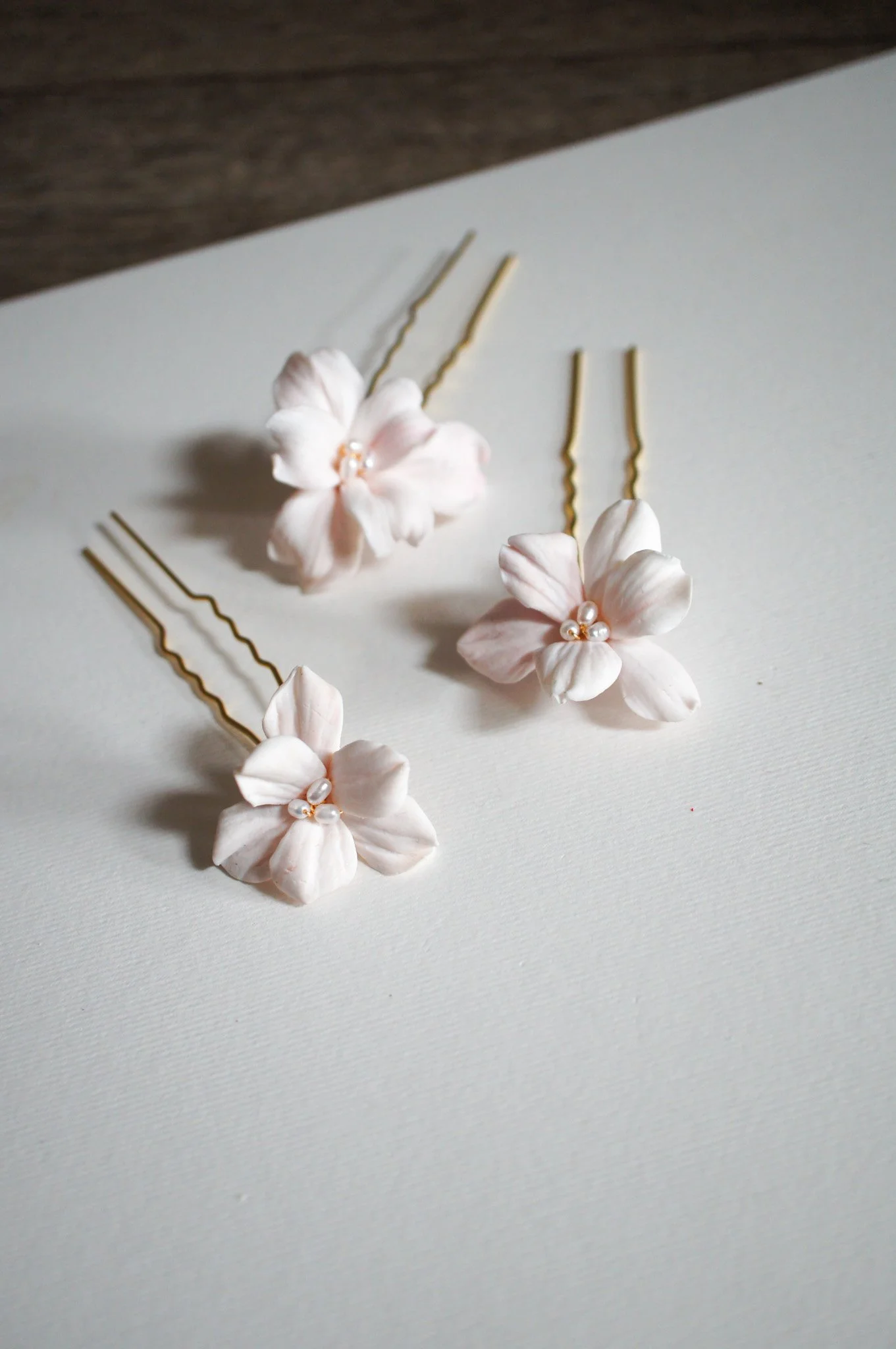 Seren hairpin set of three with delicate blush pink six-petal flowers. Elegant floral bridal hair pins for weddings, bridesmaids, and gifting.