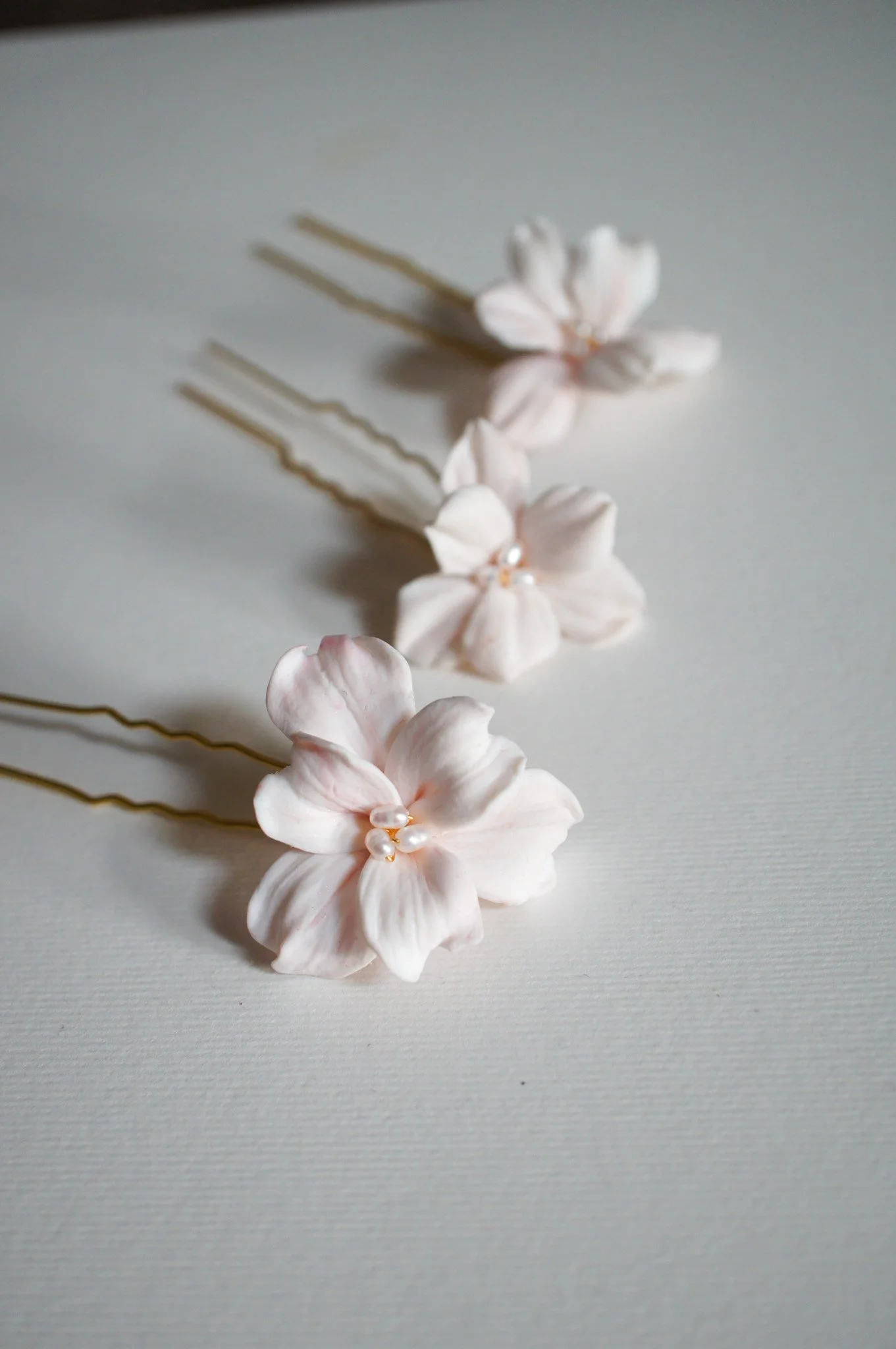 Seren hairpin set of three with delicate blush pink six-petal flowers. Elegant floral bridal hair pins for weddings, bridesmaids, and gifting.