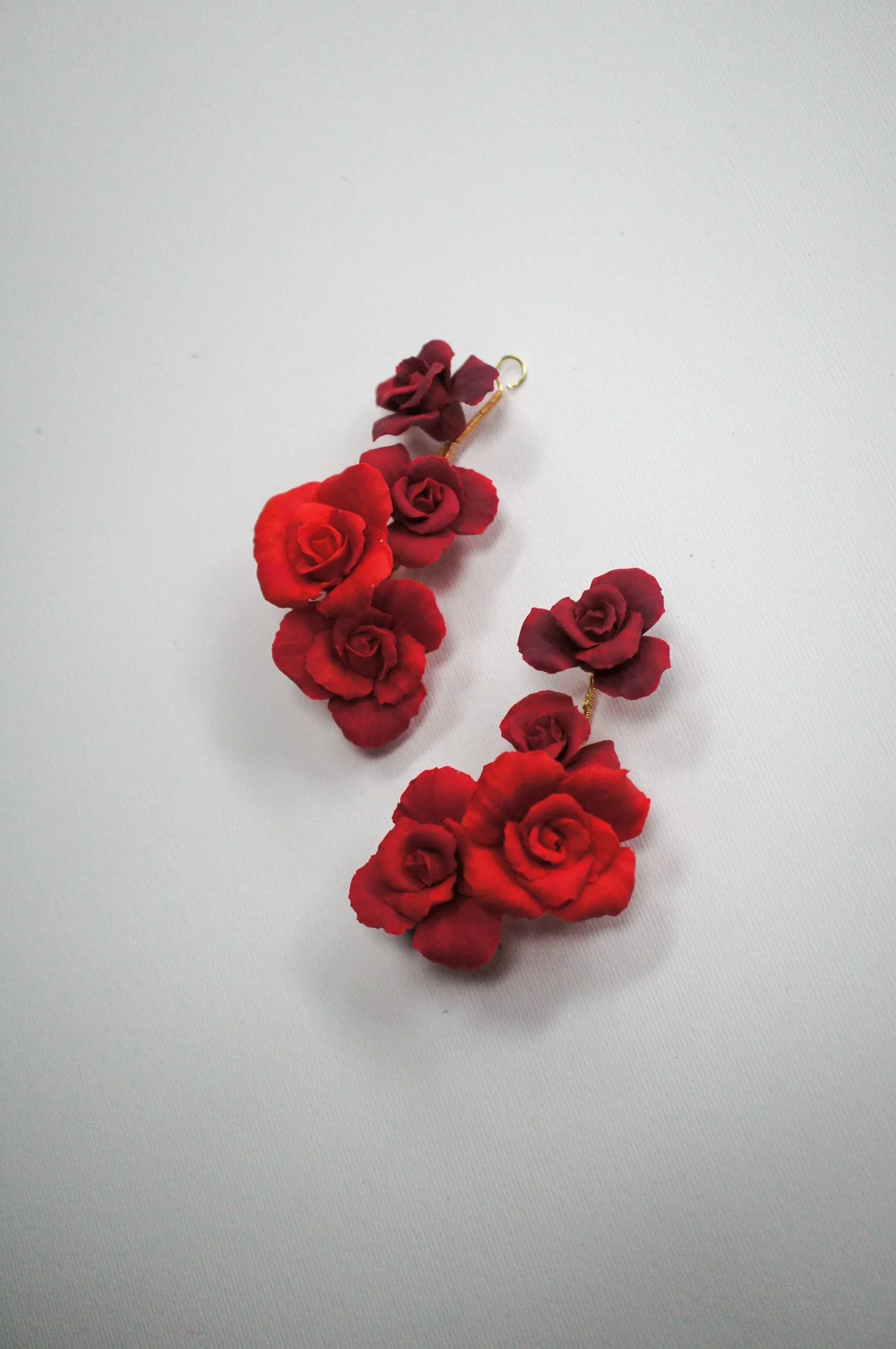 Two red rose bridal hairpieces, versatile styling for updos, side placement, or together for romantic wedding hairstyles.