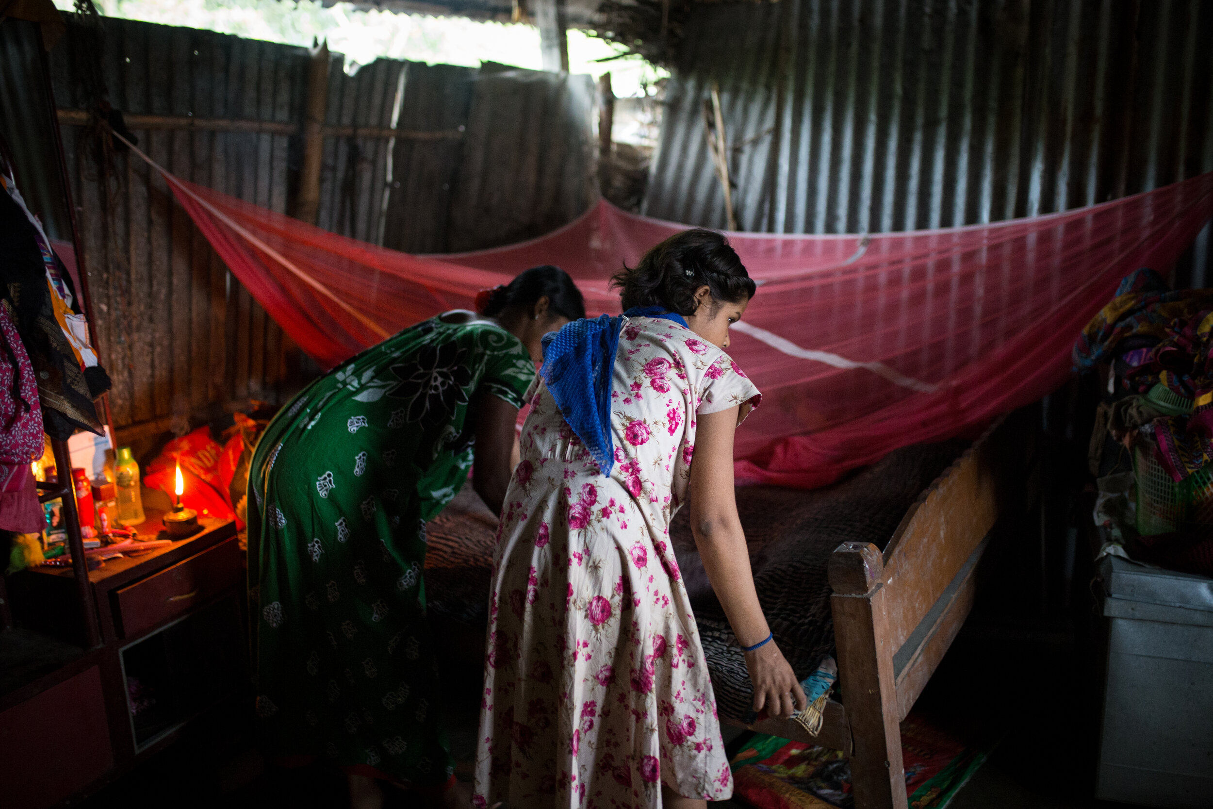  Mouli*, on the left, making the bed with her daughter in their home in West Bengal.   She was married to an abusive alcoholic at the age of 12, and suffered long years of abuse and violence. One year ago, she decided to flee, and went back to her pa