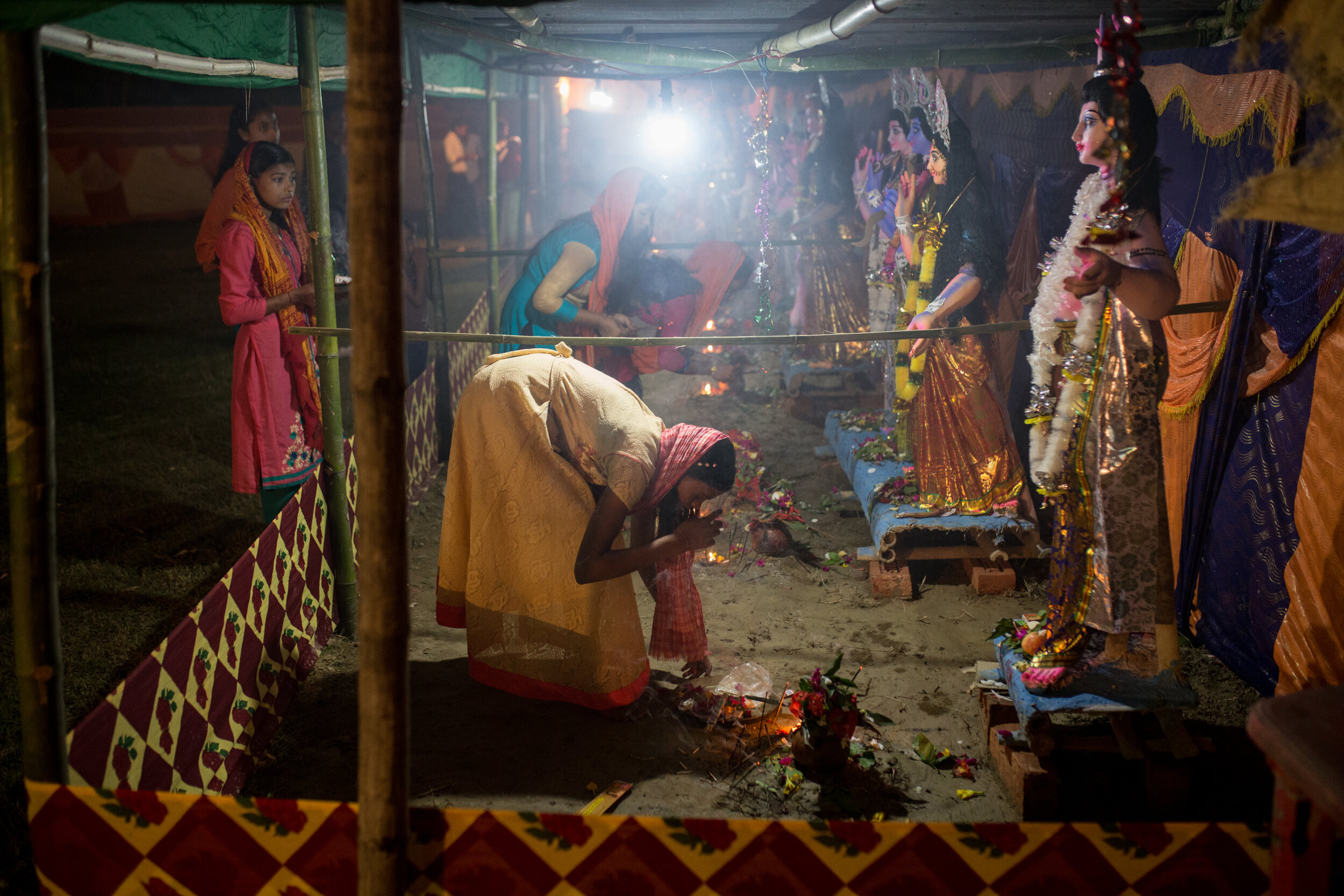  A young woman performs a puja in the Uttar Dinajpur area of West Bengal.  