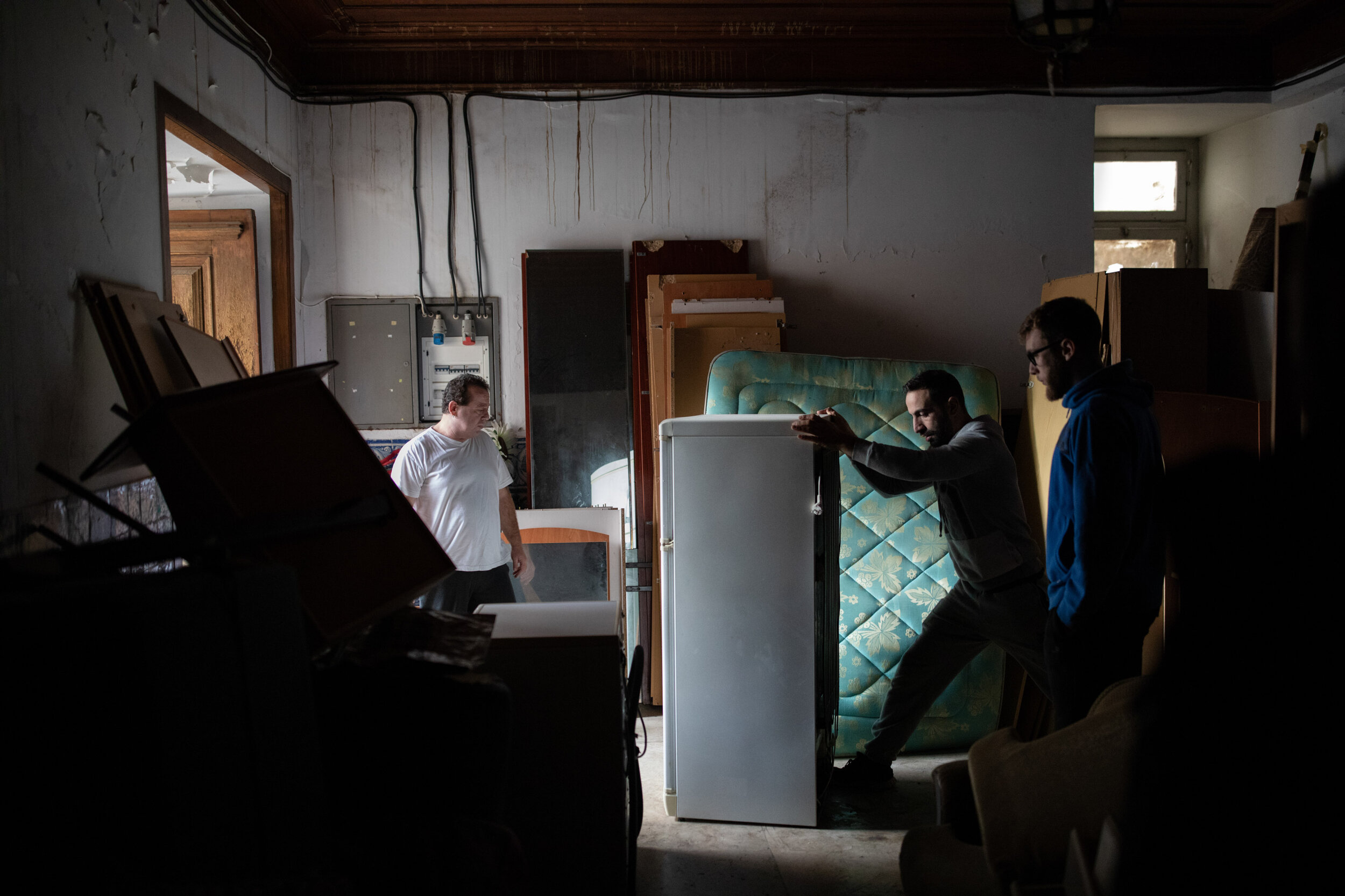  25th of November 2019   Maria Pereira’s eldest son (left) looks on as a moving crew takes her things from the wharehouse where the landlord dumped her things. After visiting her son in Luxemburg, the 78 year old Maria Pereira found the lock on the d