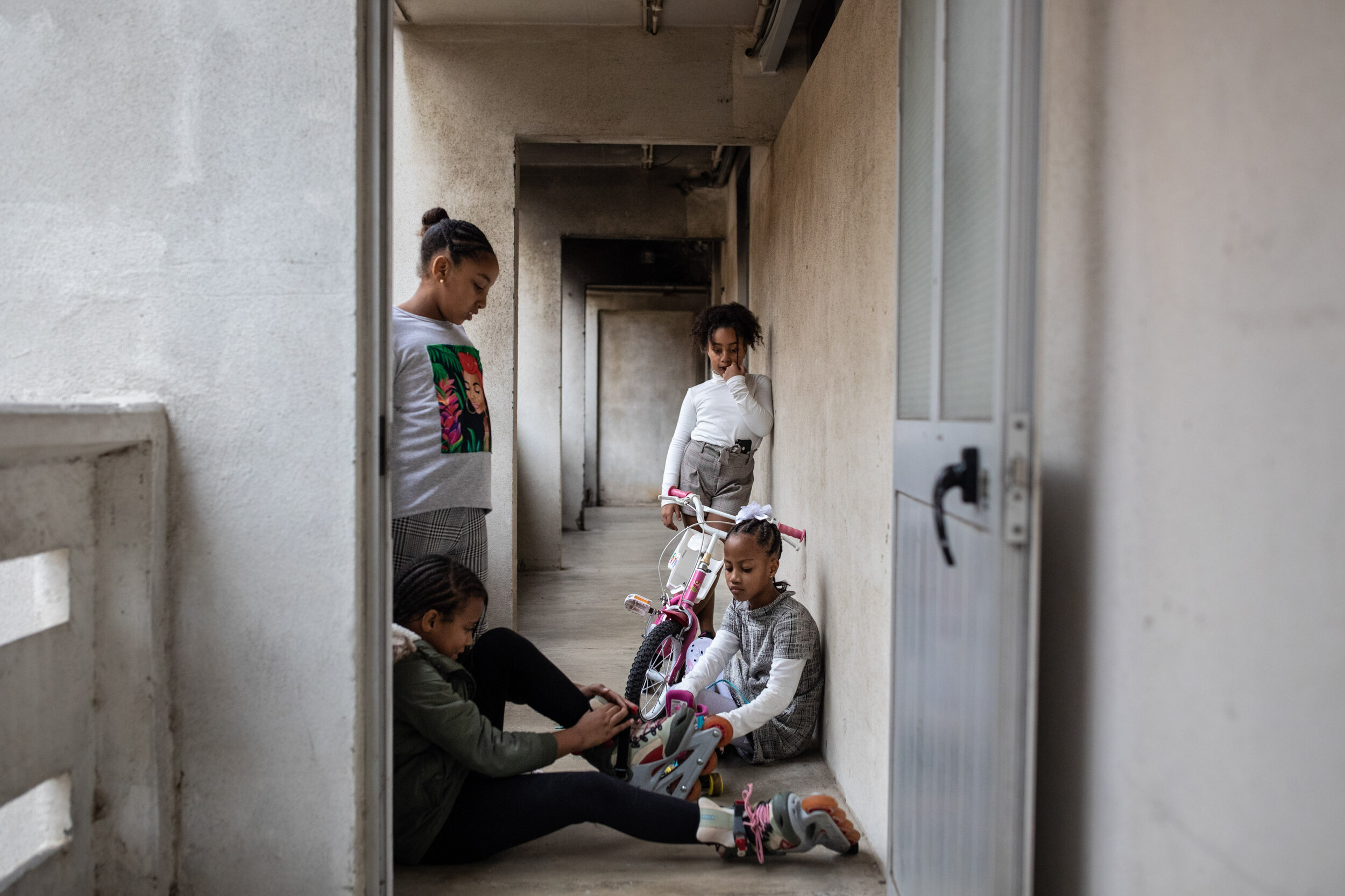  8th of December 2019   Fabiana (left) plays with her friends on a sunday afternoon in Zona J, Lisbon.   Her mother, Edna, has been squatting in an abandoned apartment in this neighbourhood for almost 4 years. 