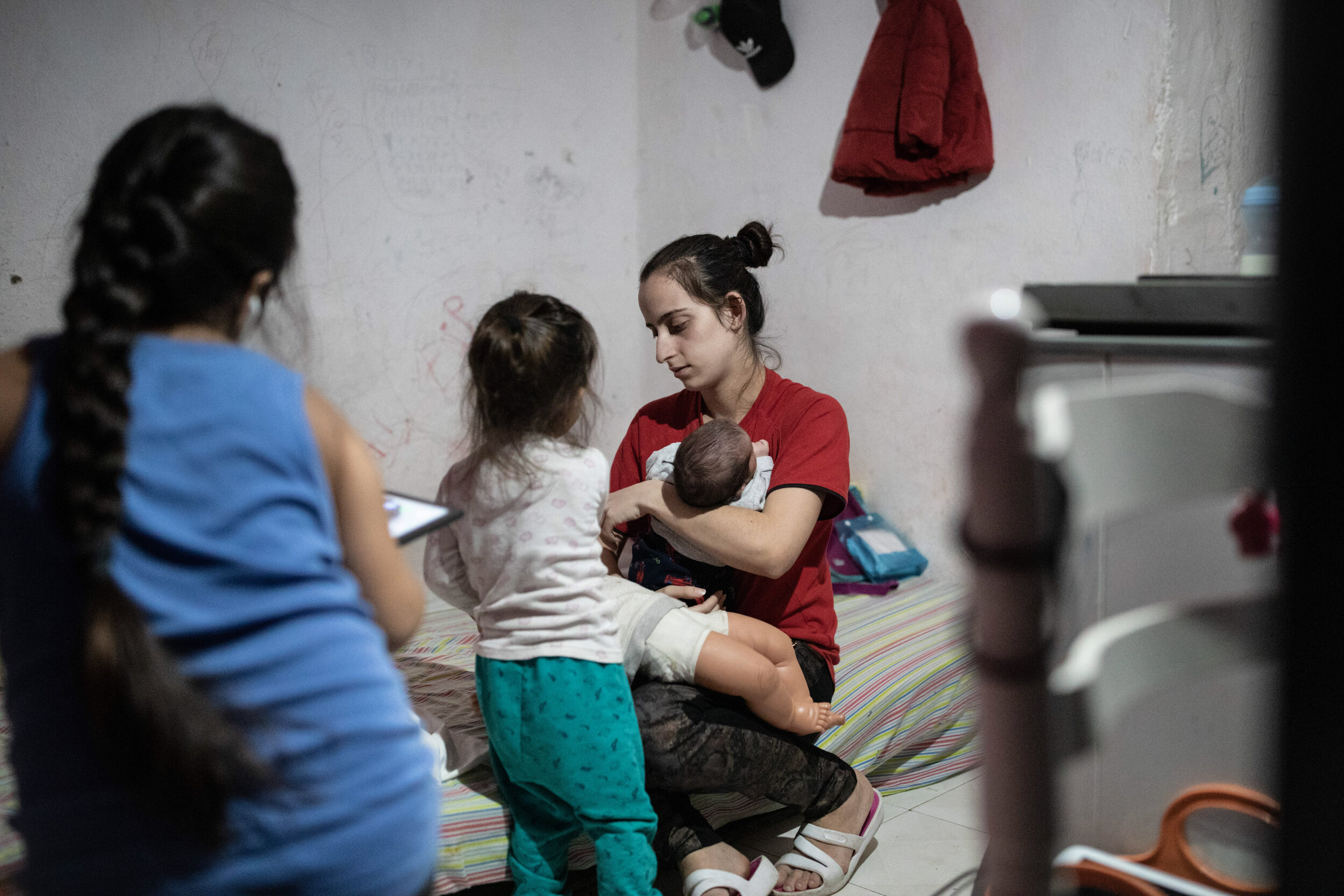  4th of March 2020   Helena's daughter in law (center) holds her newborn baby at the basement in Amadora, Lisbon the family has been living in since their home was demolished. Before coming here, Helena's family was out of choices. After the home she
