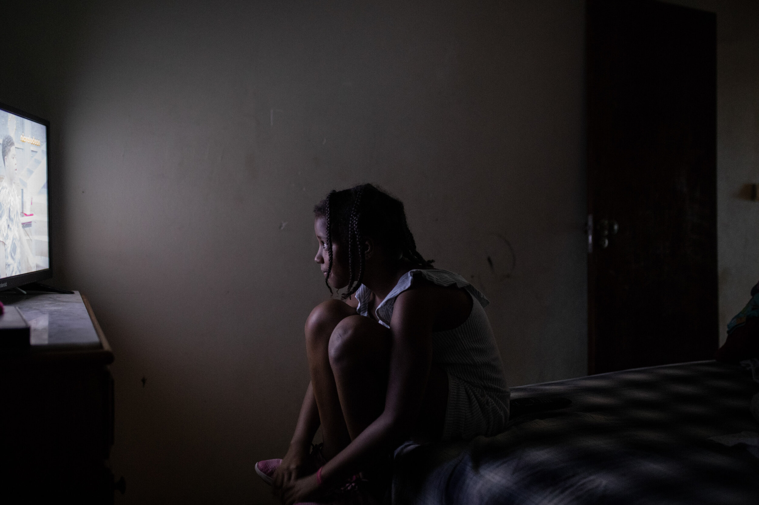  12th of October 2019   Fabiana watches TV at her occupied apartment in Zona J, Lisbon. According to housing rights activists, there are hundreds of families, many single mothers,  with no other option than to occupy abandoned apartments.    