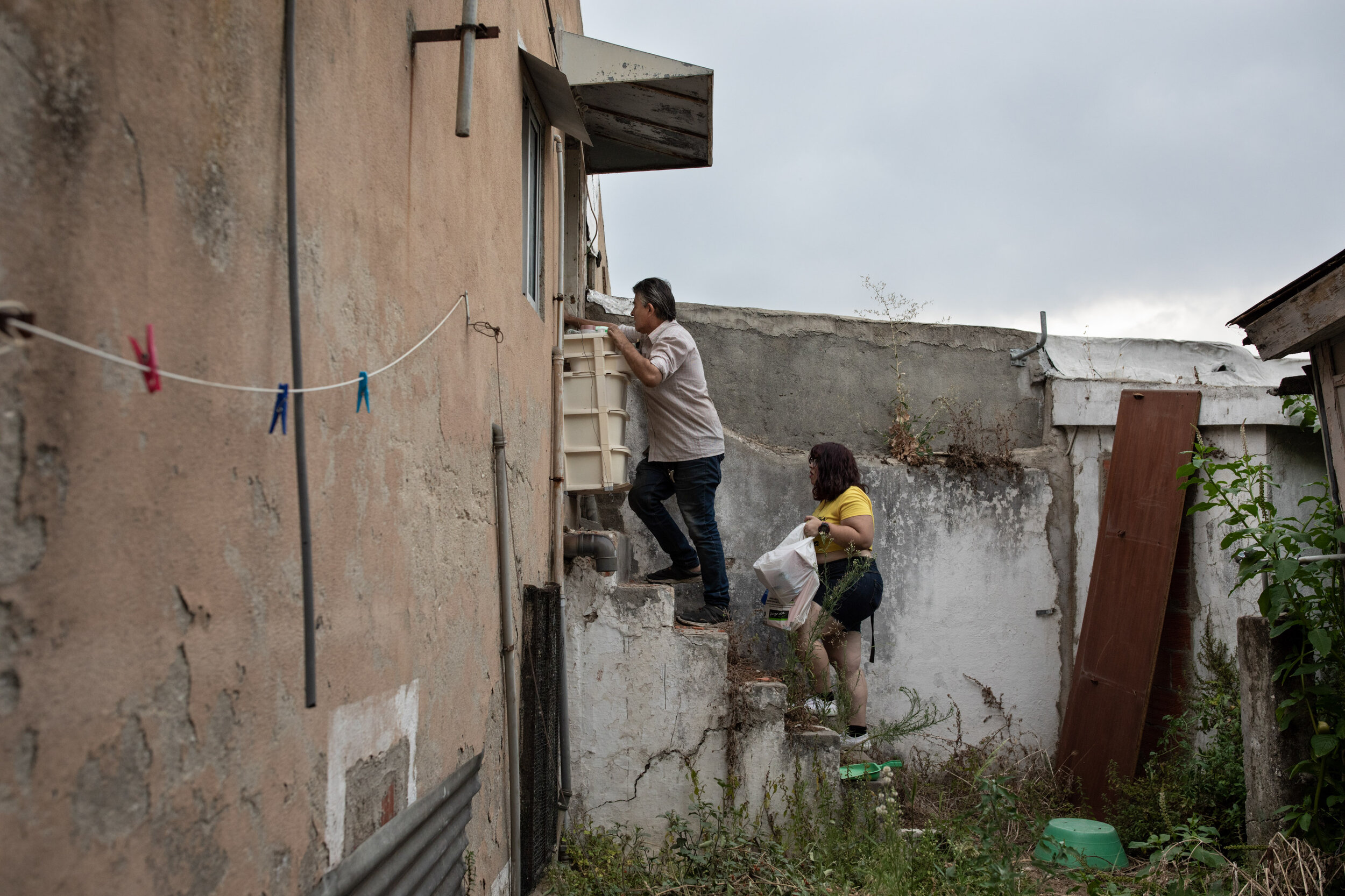  21st of July 2020      José, 53 and Marta, 26 get ready for their first night at the house they are squatting in Graça, Lisbon. Marta lost her job in March, as the pandemic reached Portugal.    