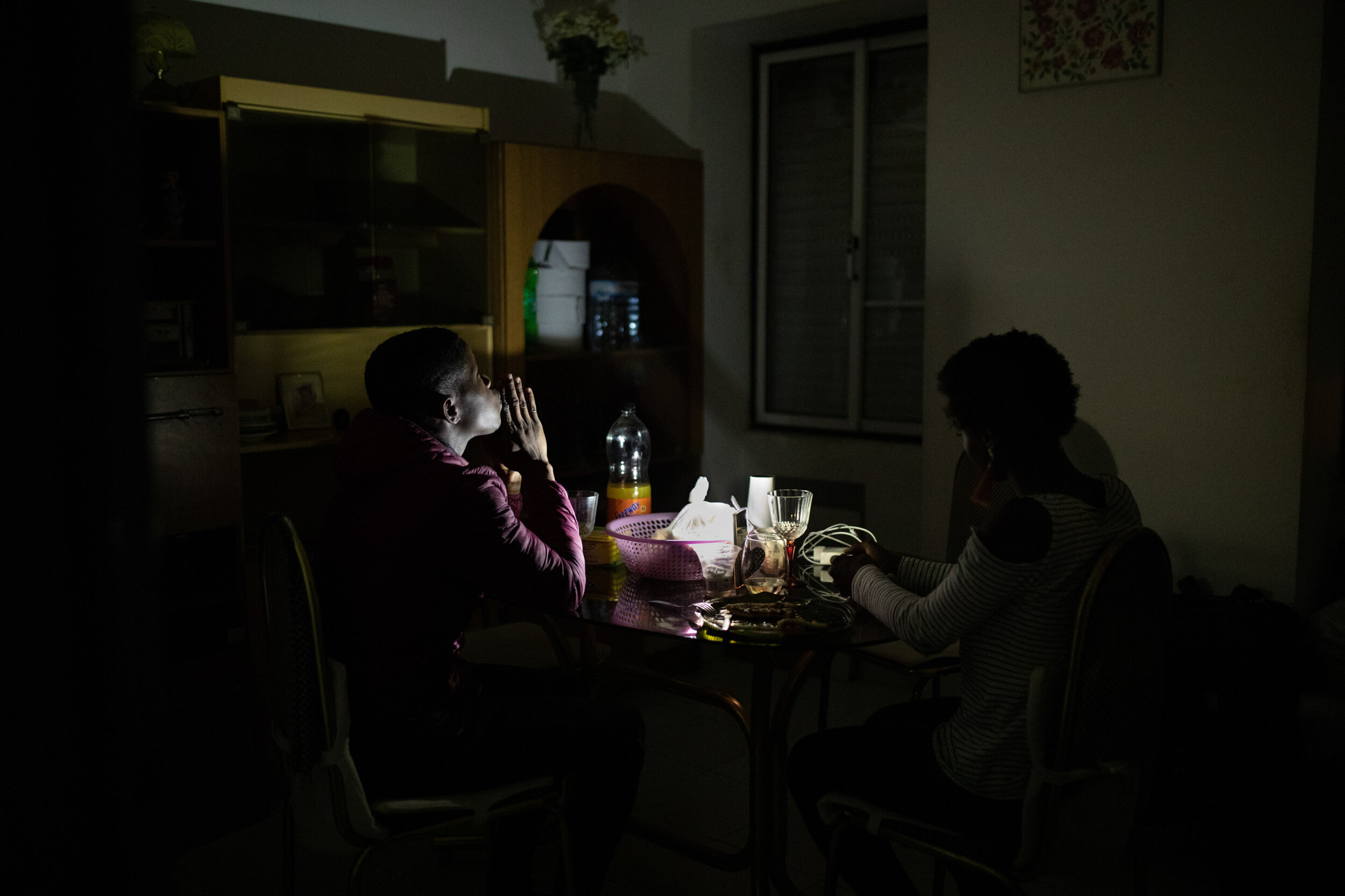  29th of May 2019   A couple have dinner at an occupied house in Lisbon after the police cut the power.   Danilson (left) and Rebeca (right), worked as a security guard and restaurant server. Struggling to pay rent in an increasingly gentrified city 