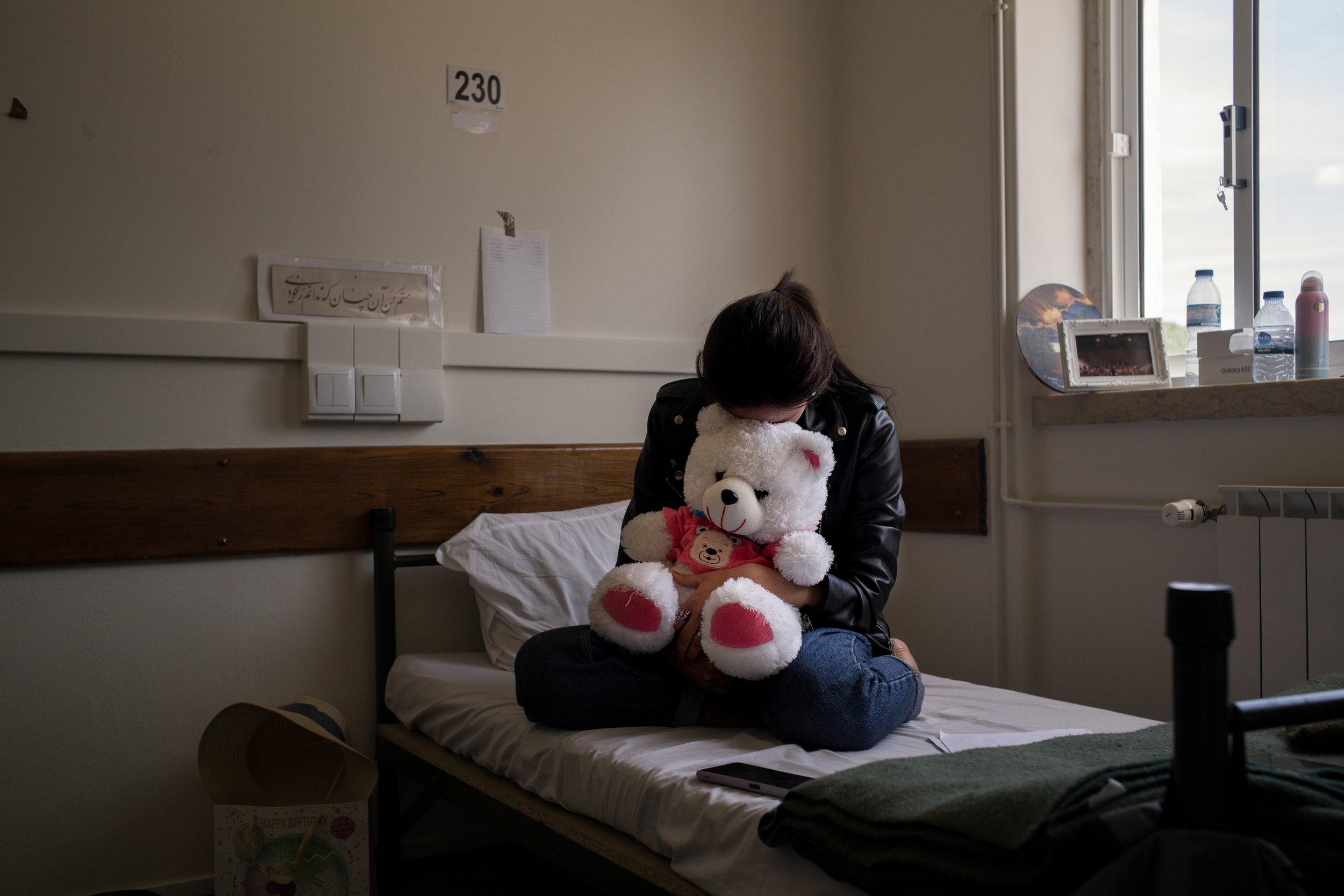  Shogufa Safi, 18, hugs a teddy bear at the former military Hospital of Ajuda, Lisbon, Portugal, where a group of about 100 Afghan refugees has been living since December. June 2022 
