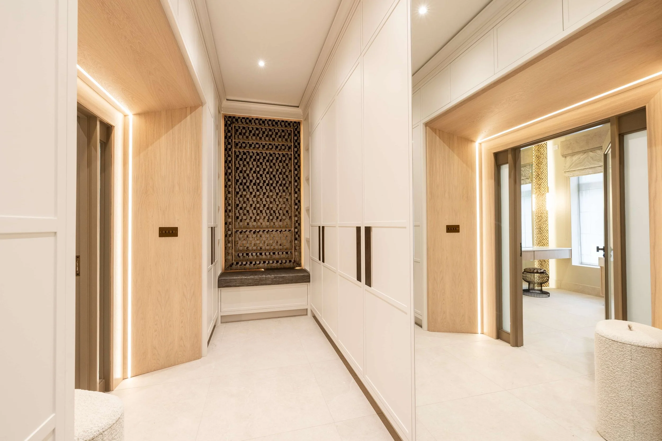 Completed hallway with bespoke fitted storage, integrated lighting and timber detailing.