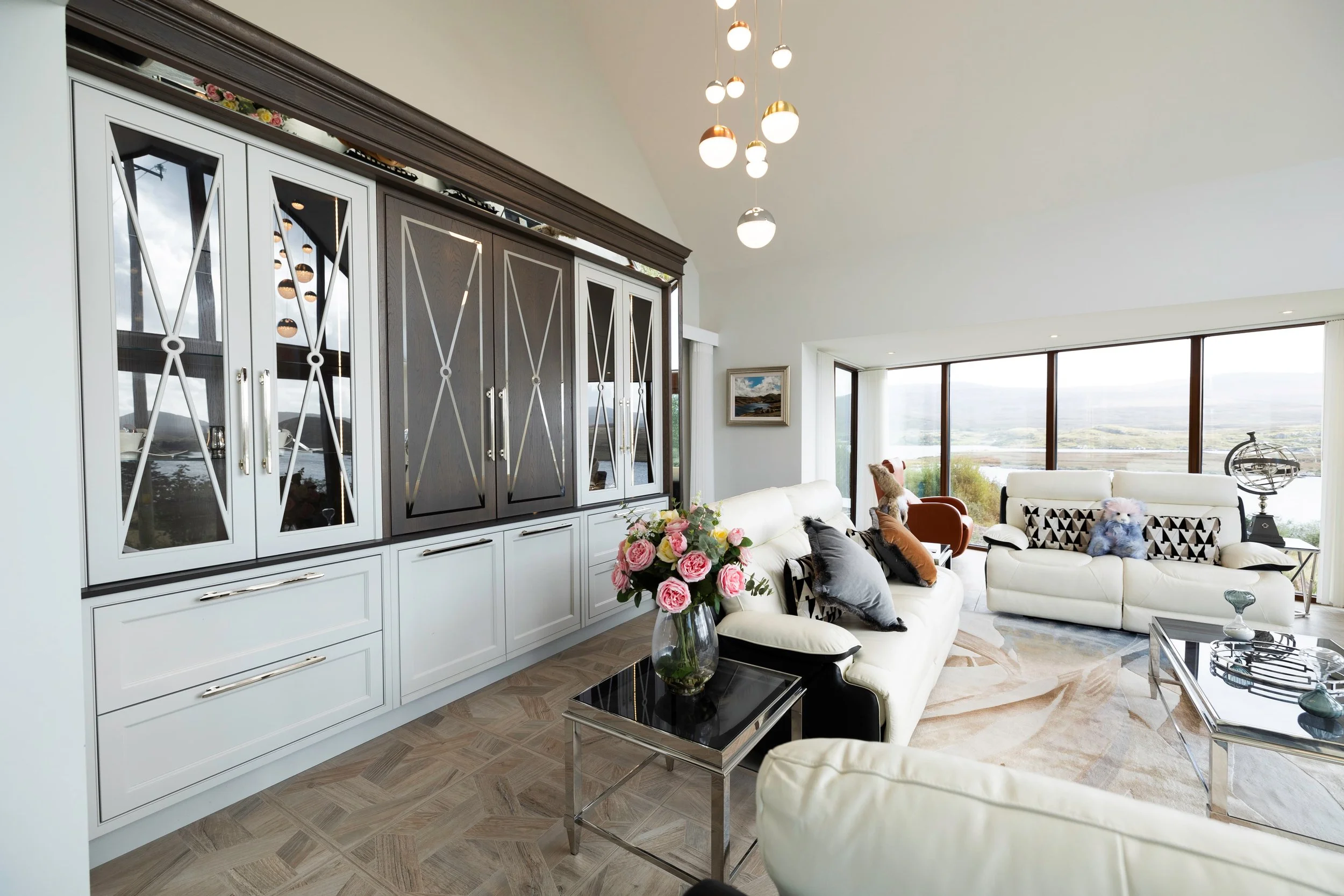 Bespoke drinks cabinet with glazed display storage and integrated lighting.