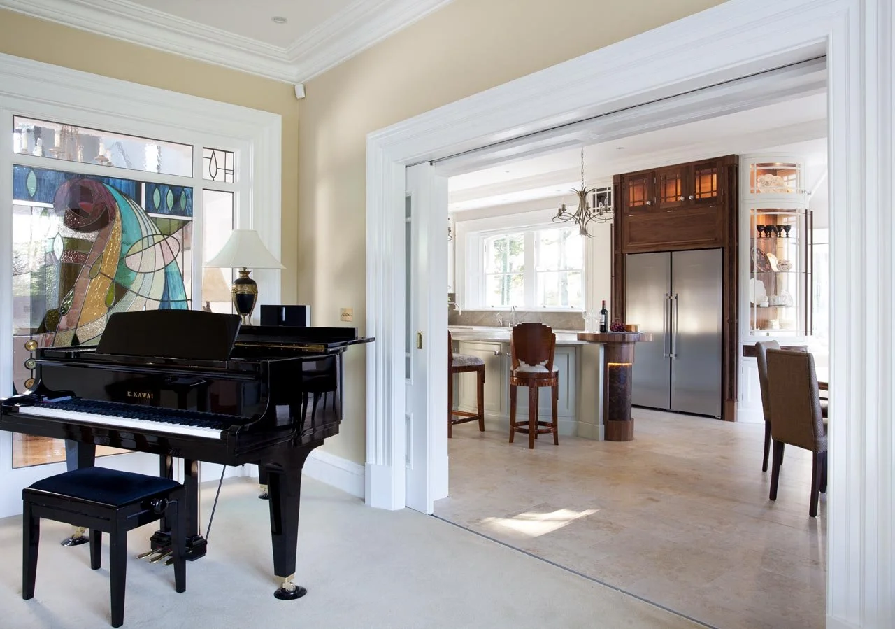 Completed open-plan interior connecting kitchen and living spaces with bespoke furniture by Darren Morgan Design.