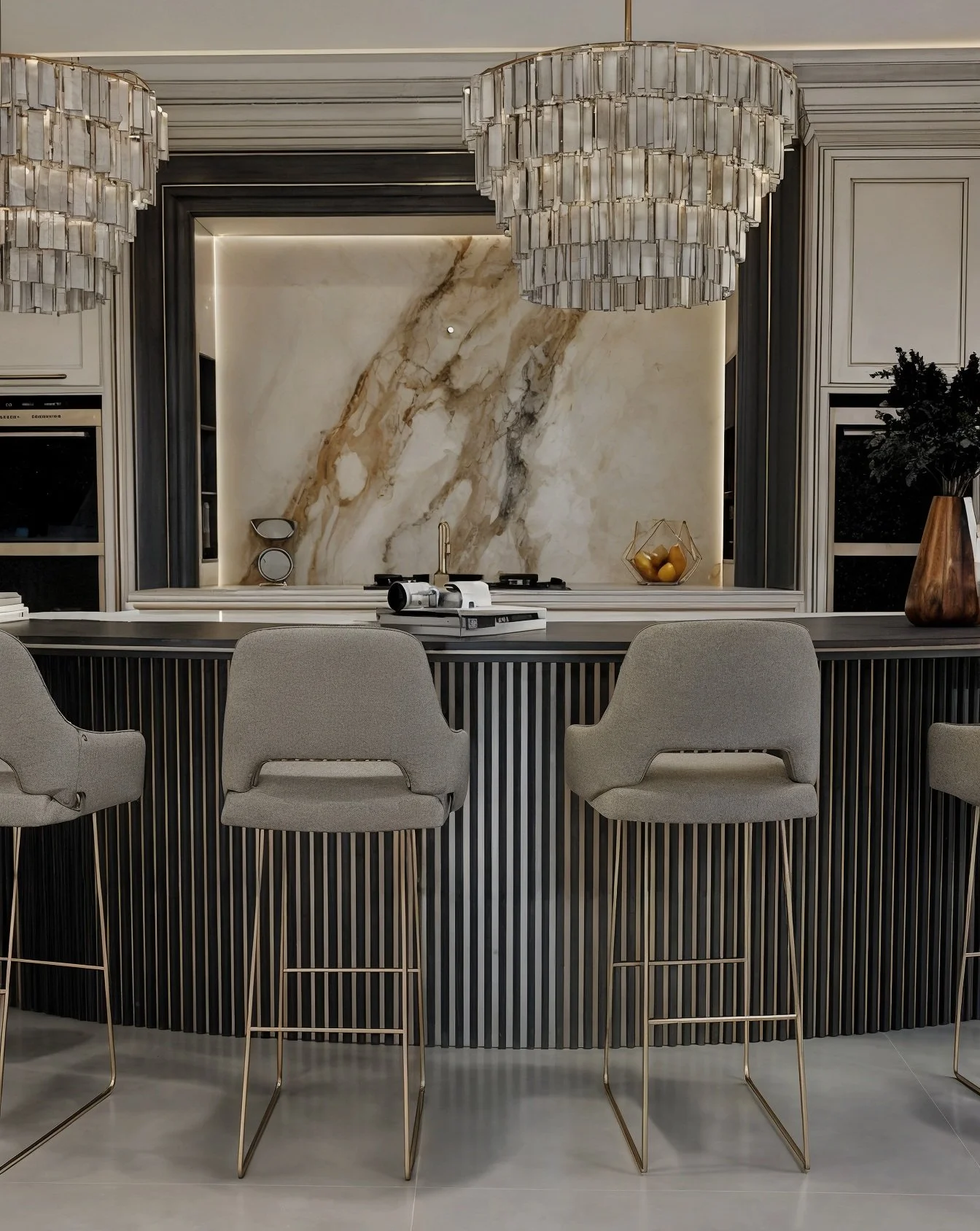 Completed bespoke bar with fluted cabinetry, marble surface and upholstered stools.