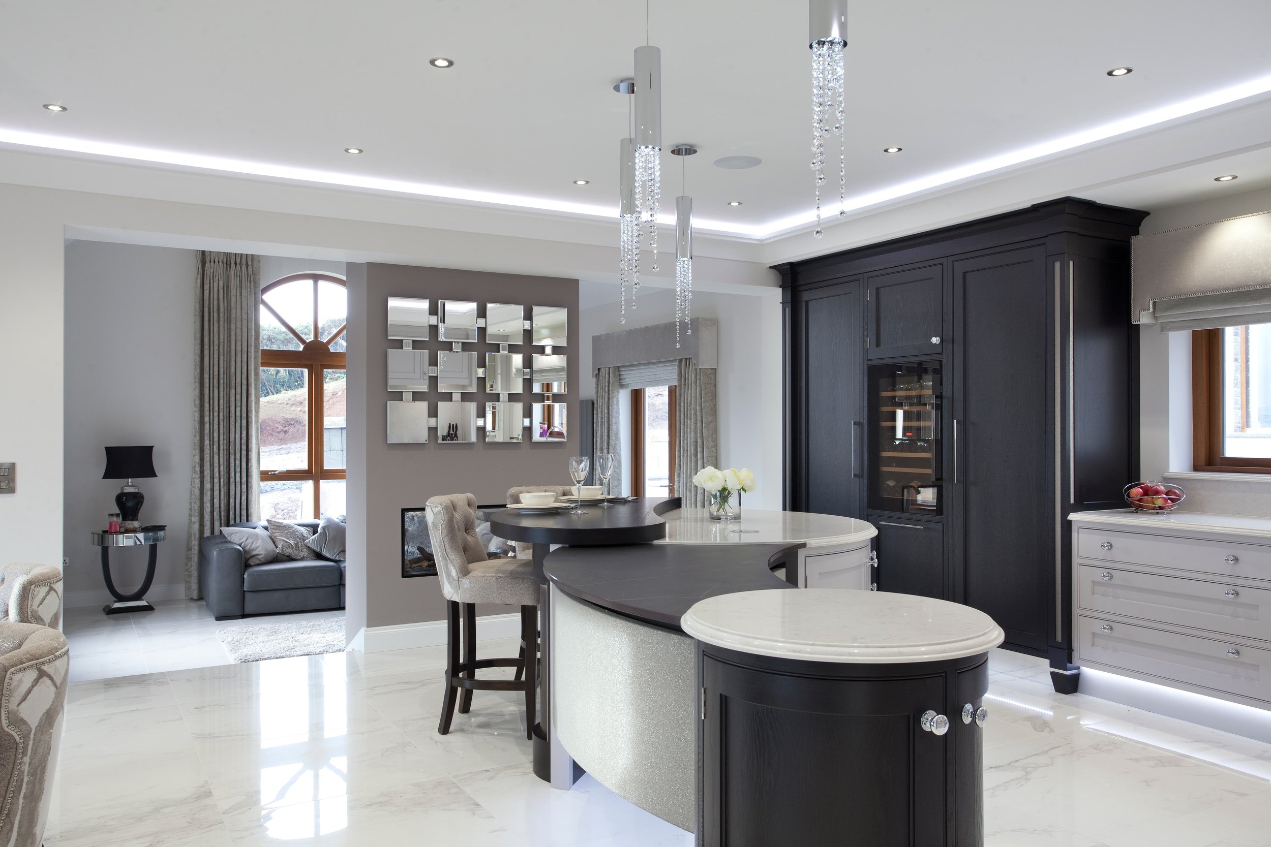 Completed bespoke curved kitchen featuring sculptural cabinetry, flowing forms and contemporary detailing by Darren Morgan Design.