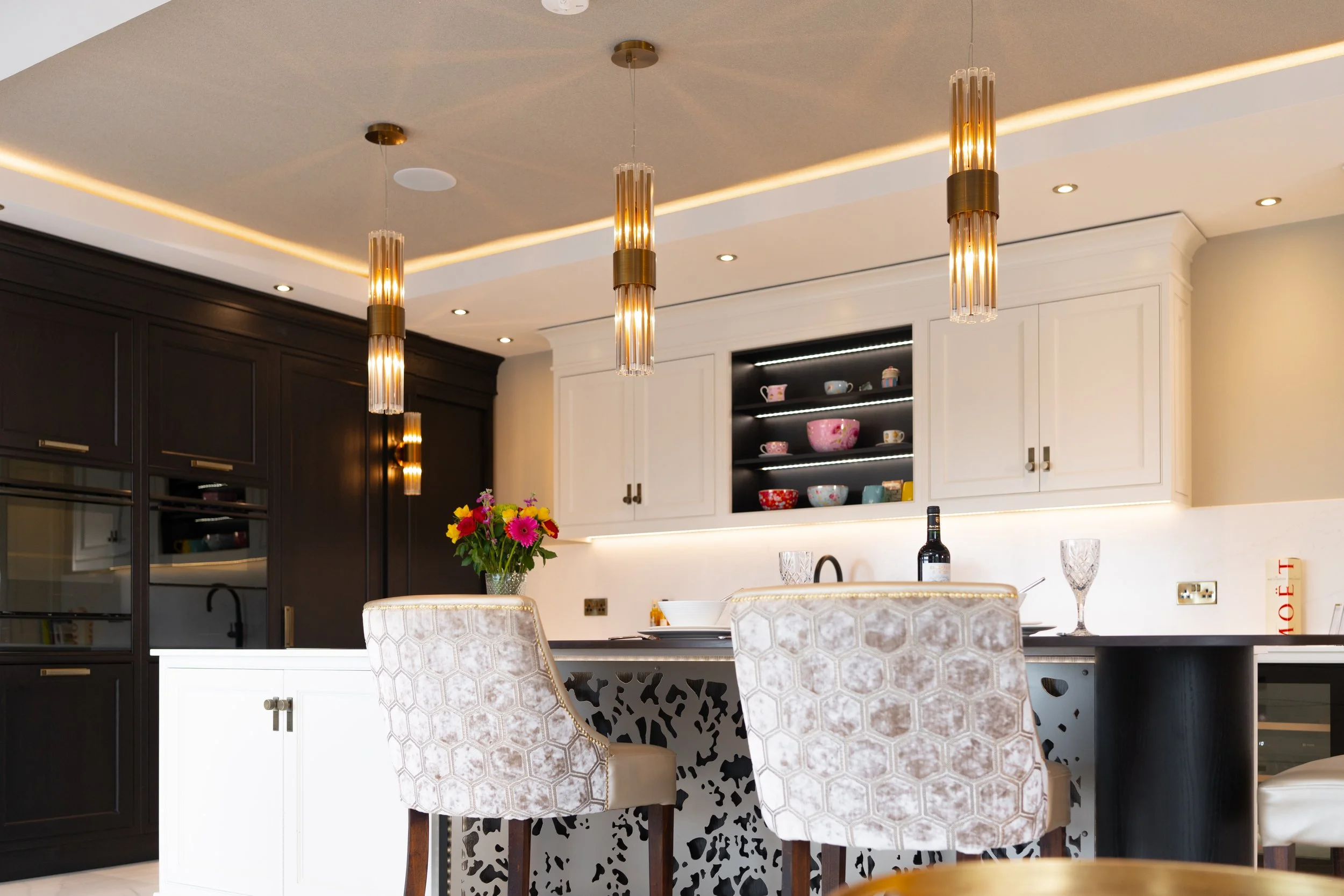 Completed kitchen with contrasting cabinetry, pendant lighting and island seating.