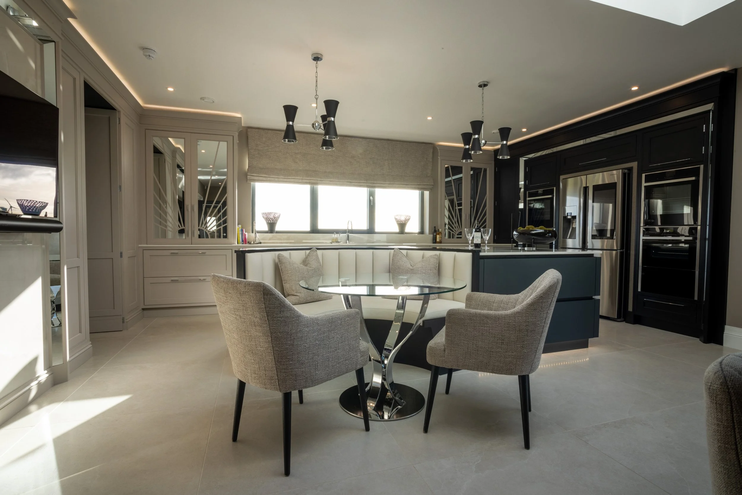 Open-plan kitchen and dining area with contrasting fitted cabinetry.
