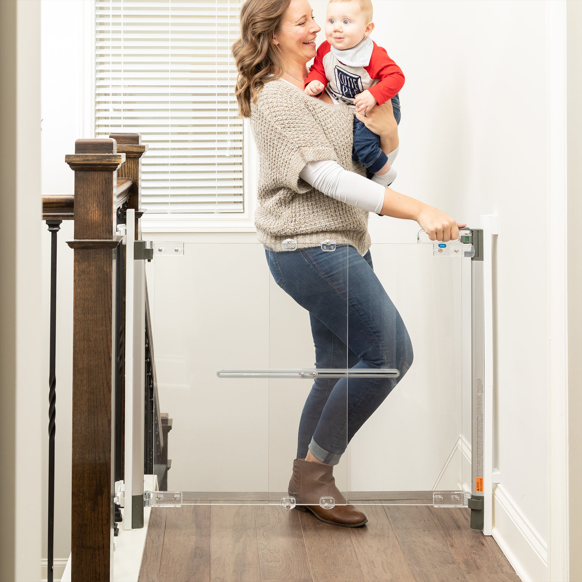 Mother opening Crystal® Designer Baby Gate at top of stairs