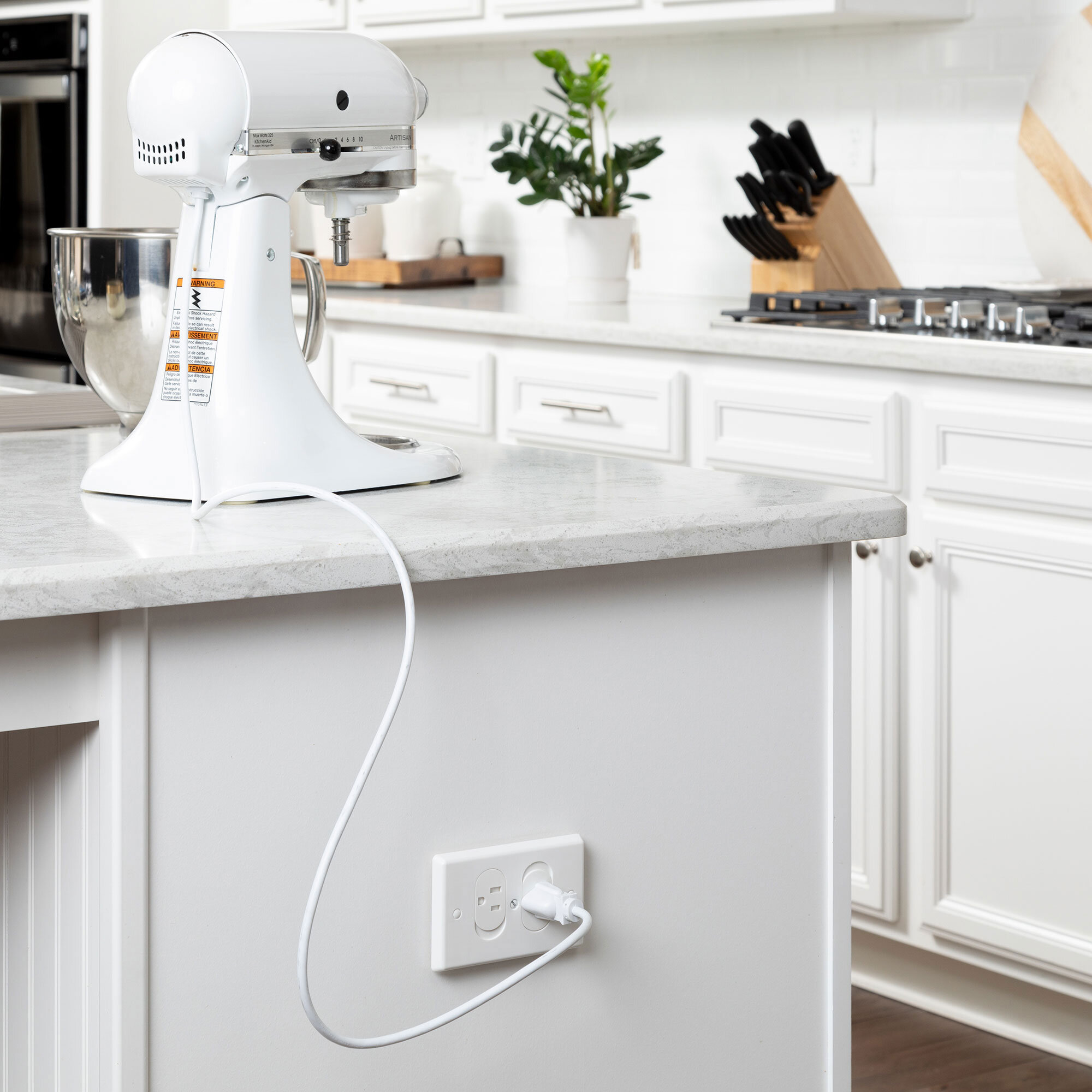 Universal Self-Closing Outlet Cover being used with a mixer in a kitchen