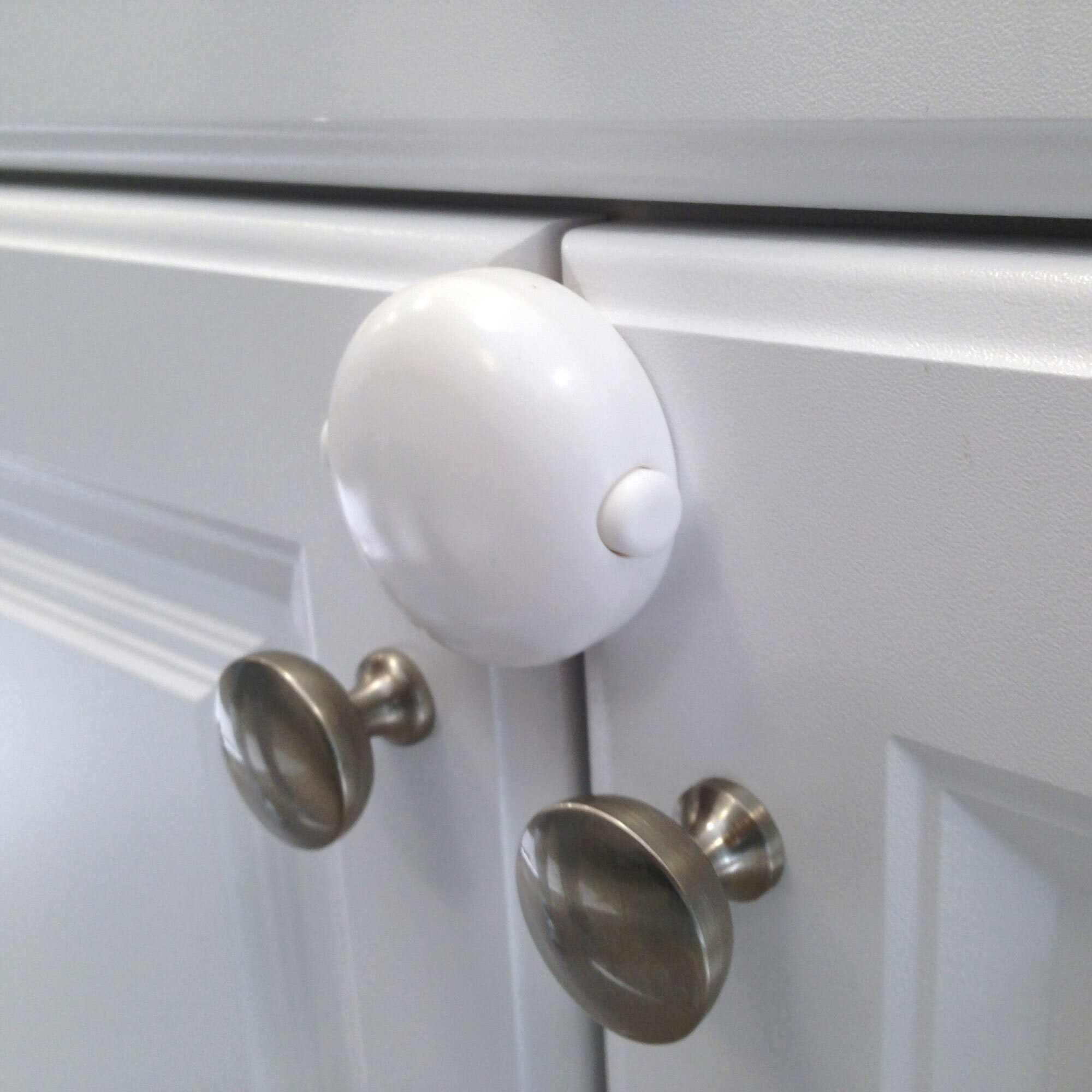 Adhesive Double Door Lock on white cabinet