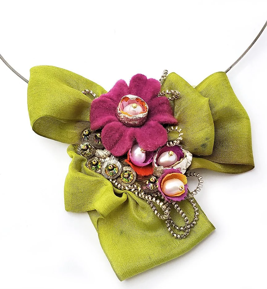 silver necklace with green silk bow center embellished with vintage flower bead, pearls and precious metal clay pods and silver cannetile wire