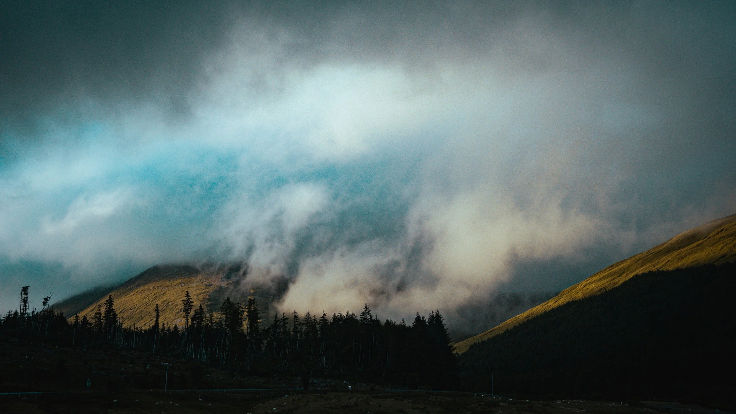 The mist-covered mountains {Sandy Ravaloniaina/Unsplash}