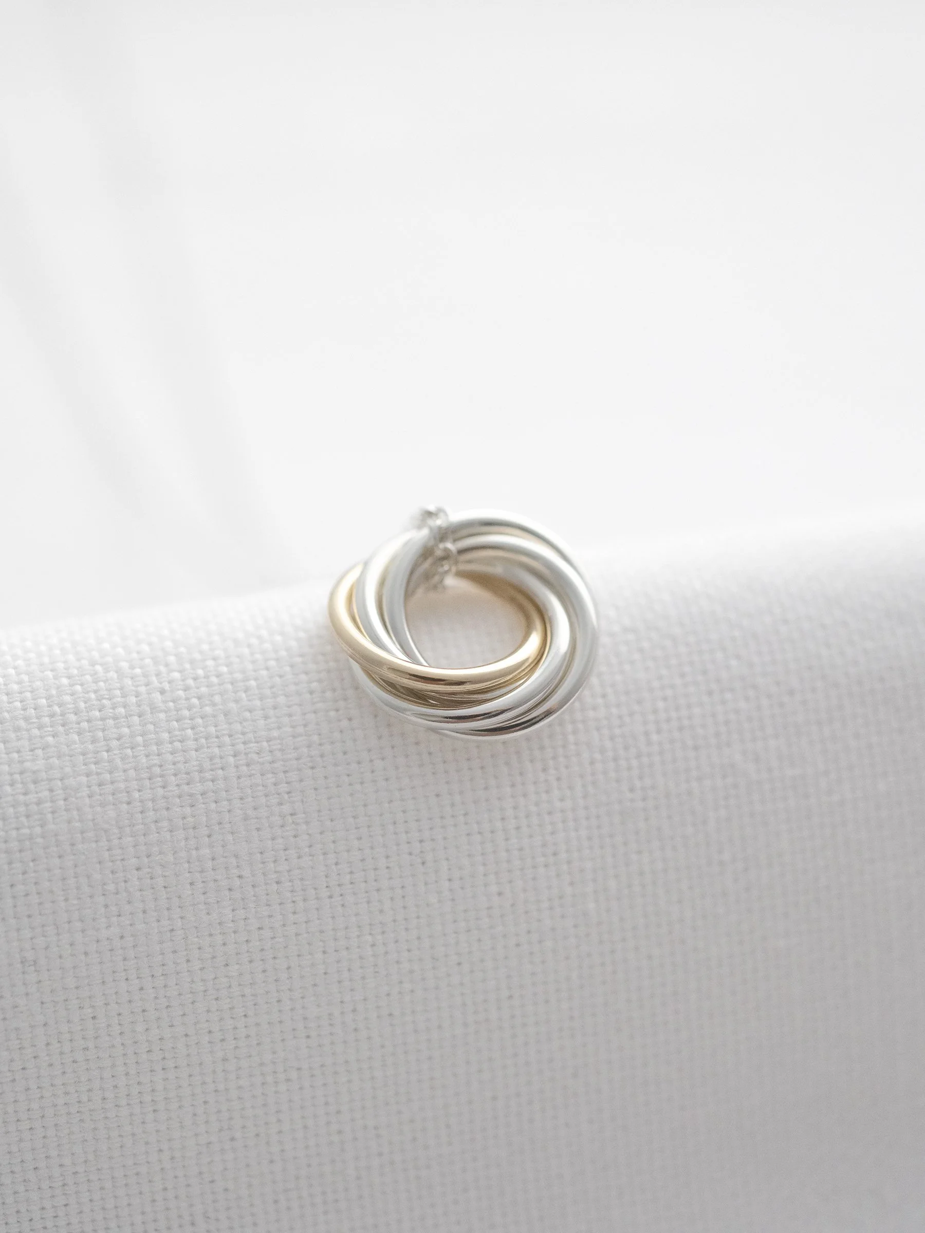 A unique 50th birthday necklace displayed on white material.