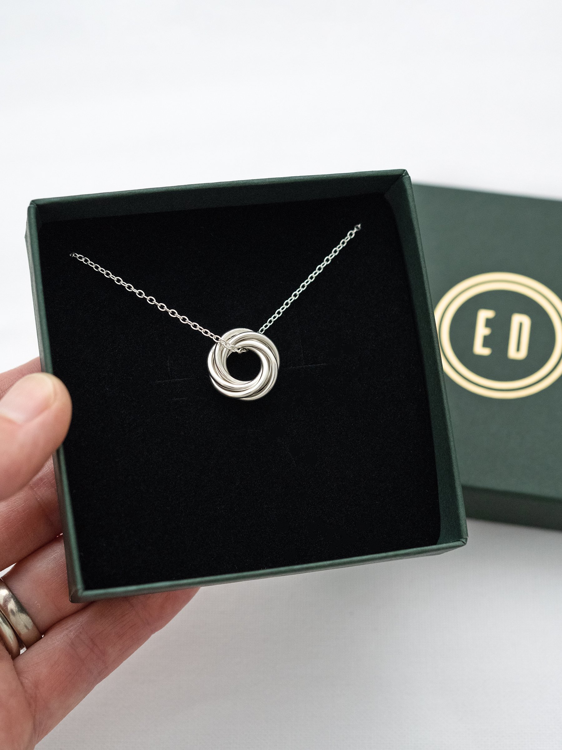 A handmade silver 60th necklace displayed in the jewellery presentation box.