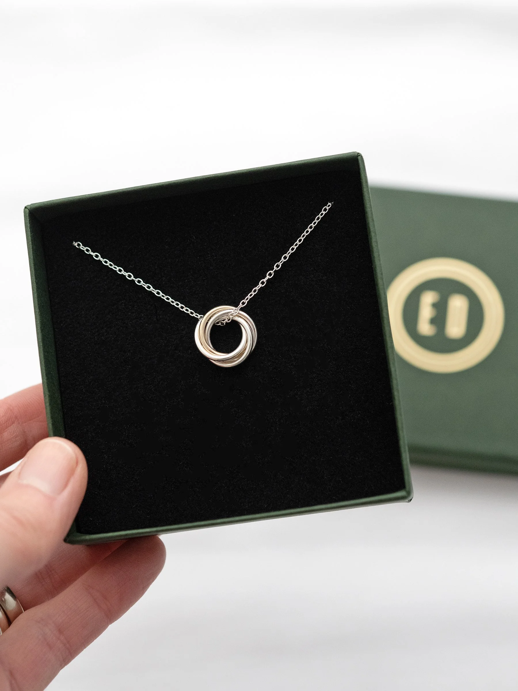 A gold and silver 40th birthday necklace displayed in an Elizabeth Designs jewellery presentation box
