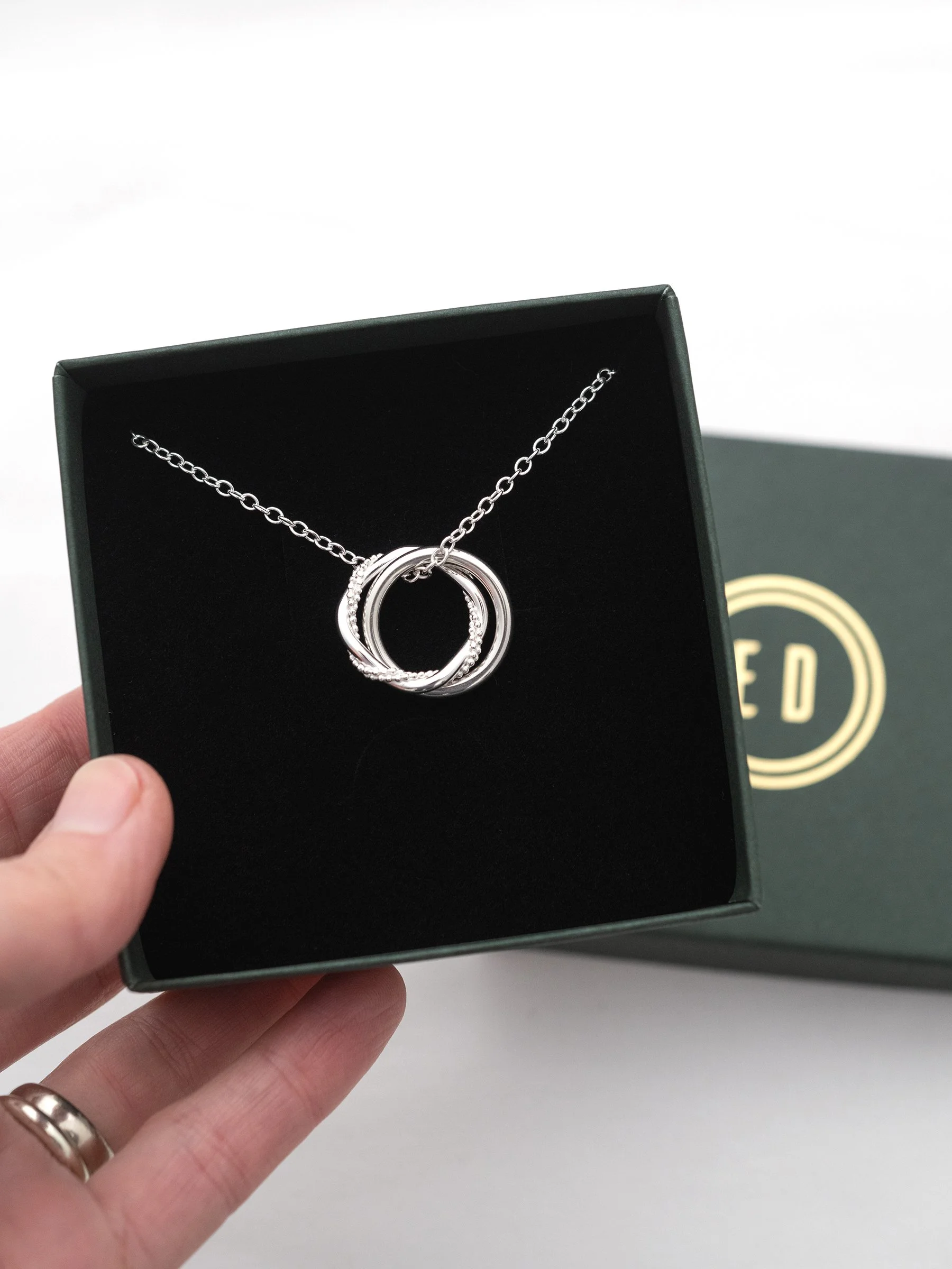 A sterling silver 21st necklace displayed in an Elizabeth Designs jewellery presentation box.