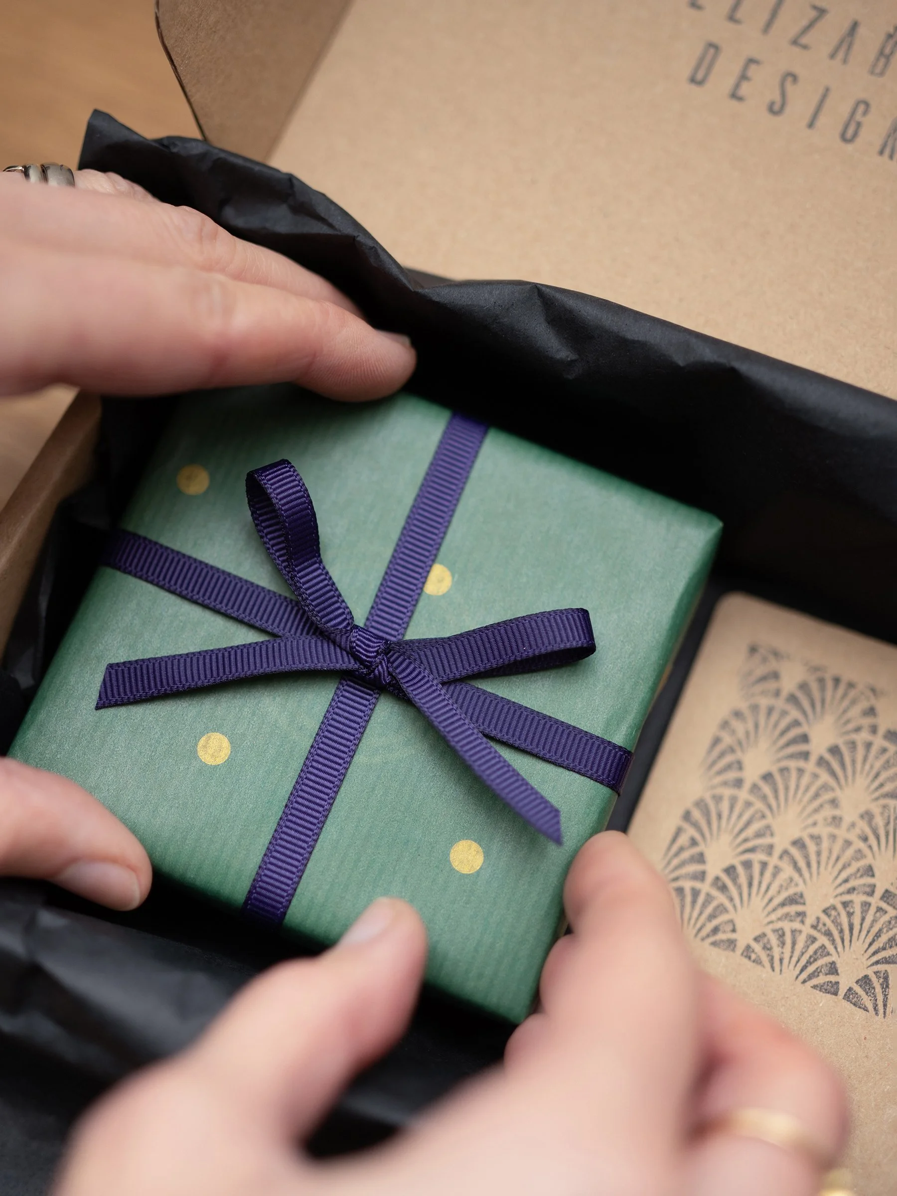 A close up of Elizabeth Designs jewellery box gift wrapped with a gift card.