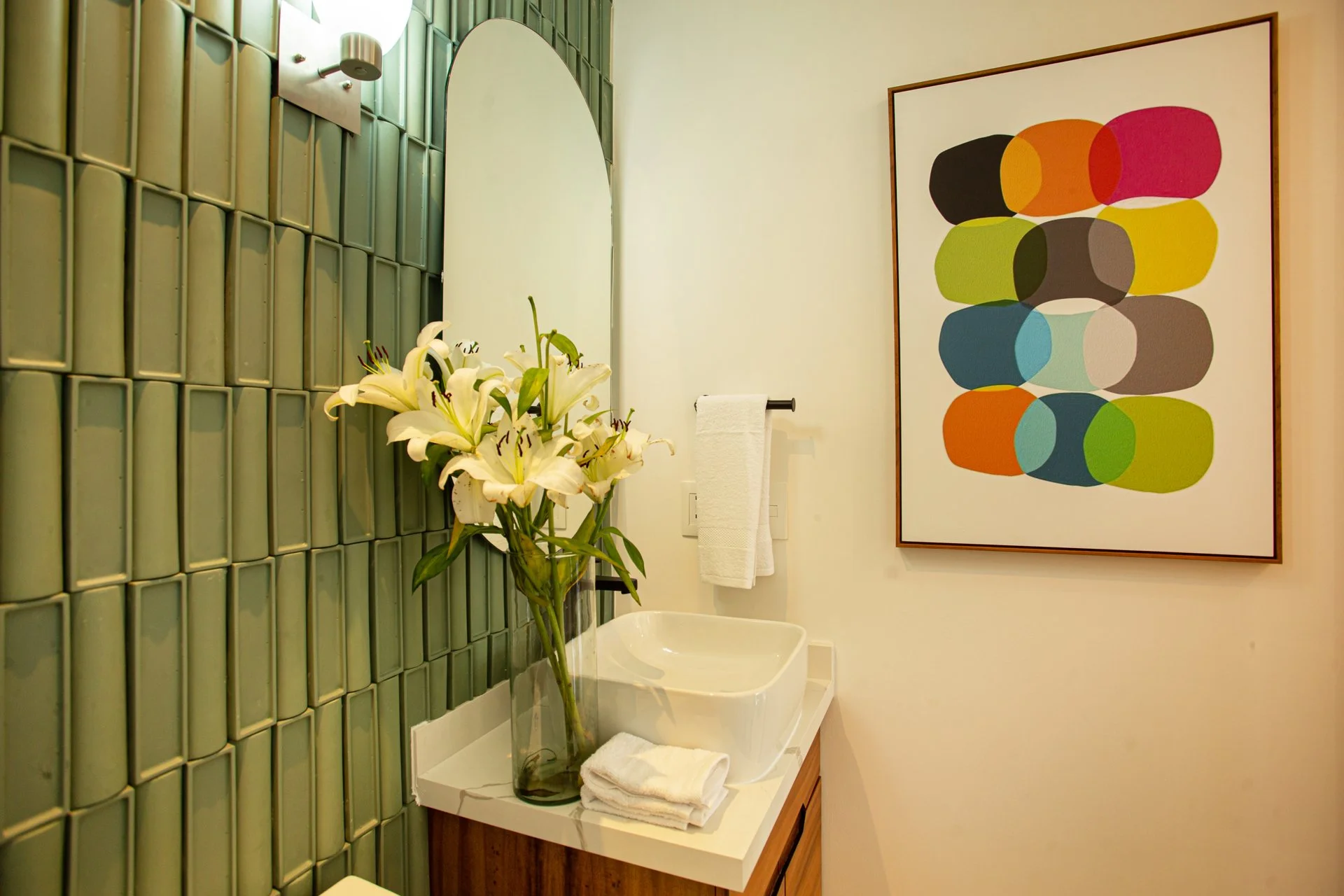 A beautiful, bespoke primary washroom featuring curated artwork, upgraded tile and every guest amenity to drive Airbnb bookings.