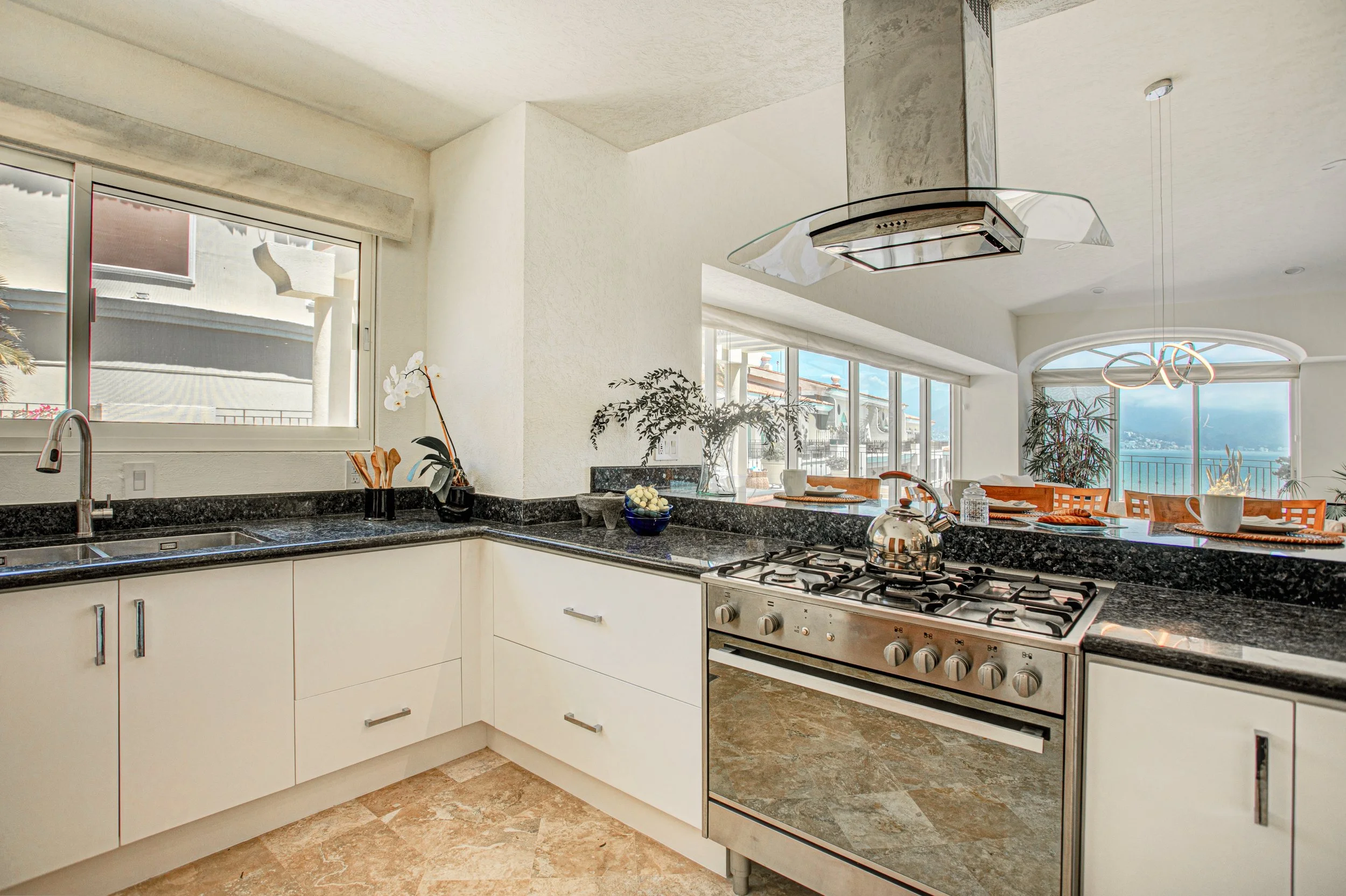 A full scope kitchen overhaul.  PORTOFINO penthouse, Marina Vallarta Mexico. Opening the pass thru to the bar, livingroom and outside pool deck was this owner's secret sauce!