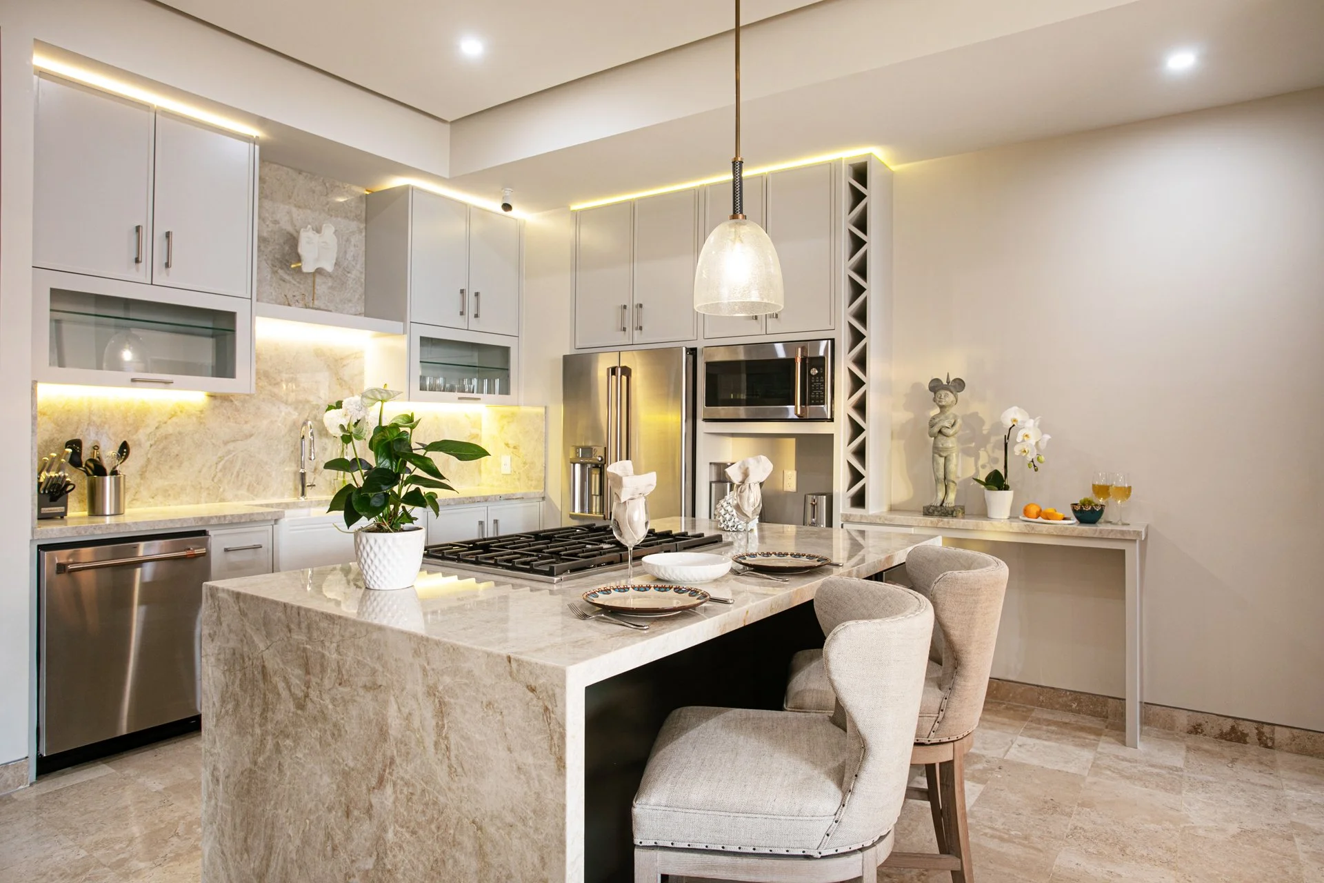 A full gut chef's kitchen transformation in Bucerias Mexico. Taj Mahal quartz, GE Cafe appliances, wine fridge, custom wine storage, bespoke lighting and swivel bar stools.