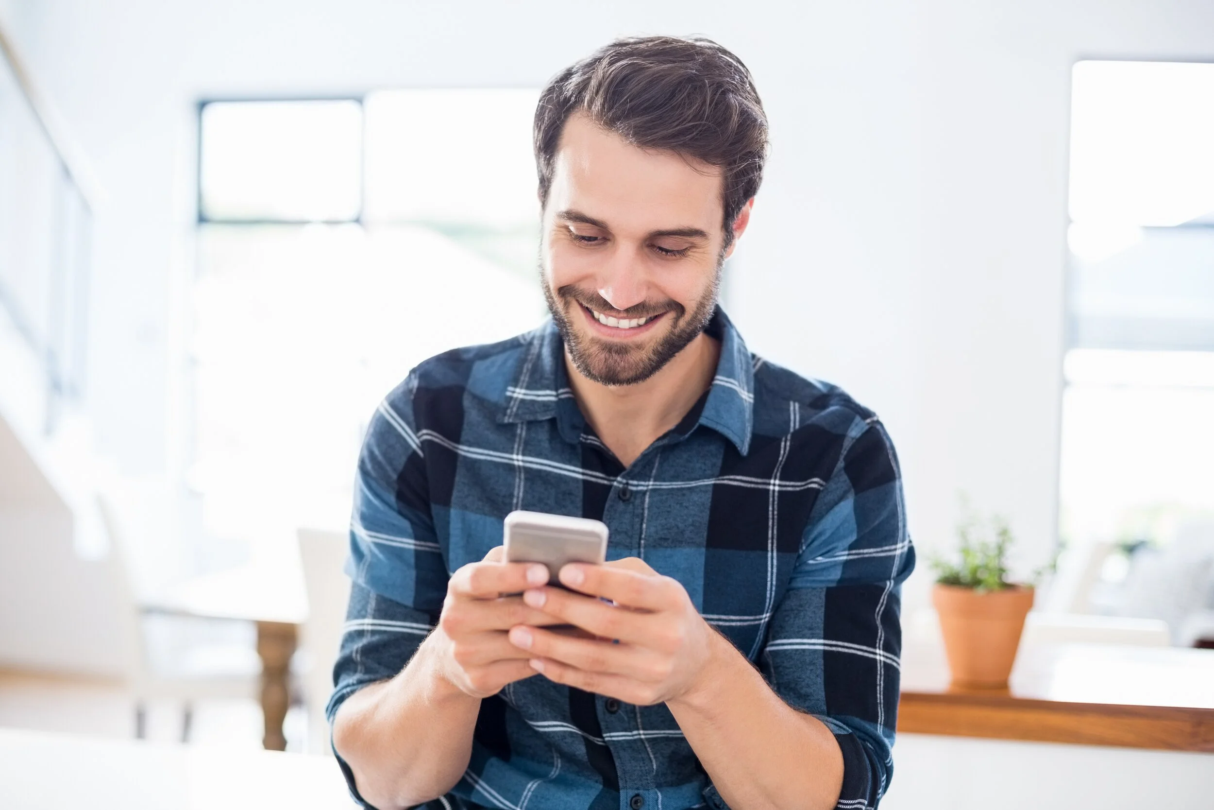 Man smiling while on his phone