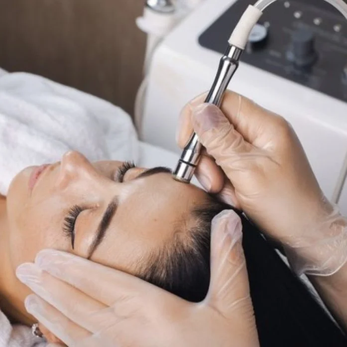 Person receiving a microdermabrasion facial treatment