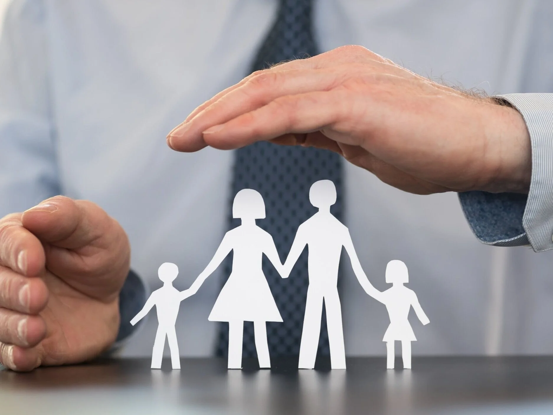 insurance agent with family in his hands