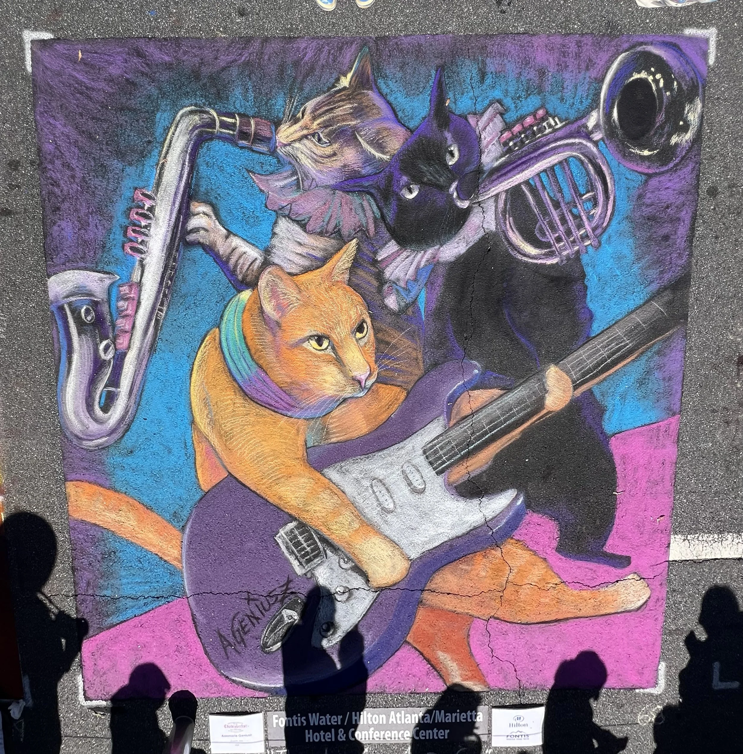 “The Amazing Acro-Cats!” Was created for Chalktober Fest in Marietta, GA in October 2025. It celebrated a local cat rescue group that performs as a rock band. It was 10 ft by 10 ft.