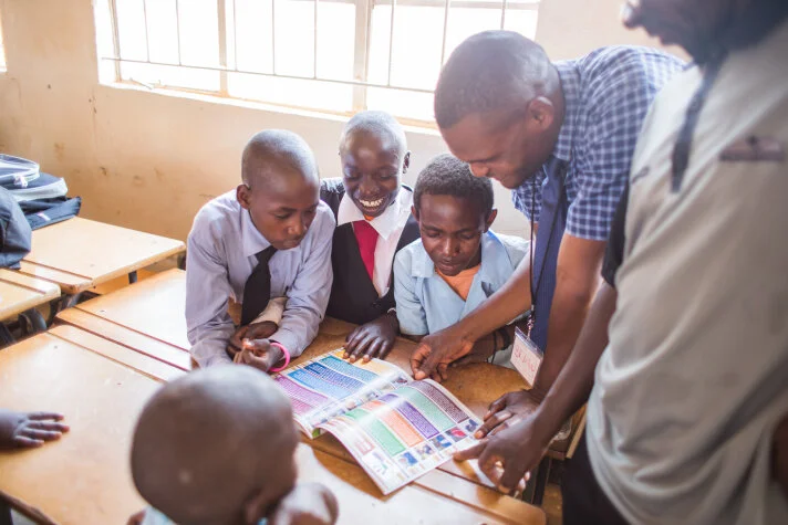 day1-zambia-ksw-boyslookingbook.jpg