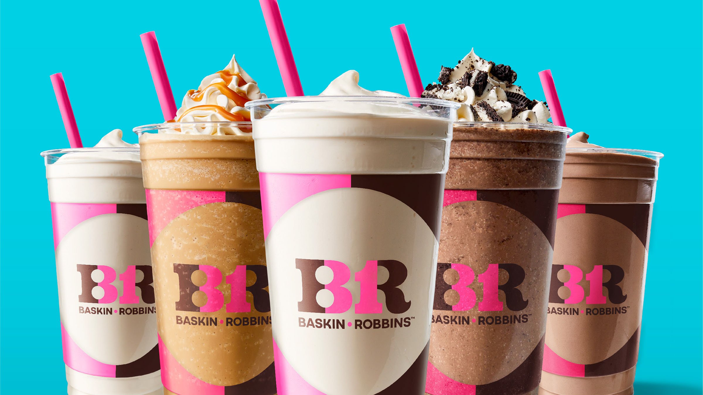Baskin-Robbins milkshakes in various flavors with whipped cream and toppings, pink straws, against a blue background.