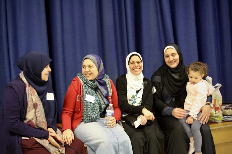 Sisters sitting together and talking at MFC