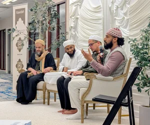A panel of speakers on stage at an MFC event