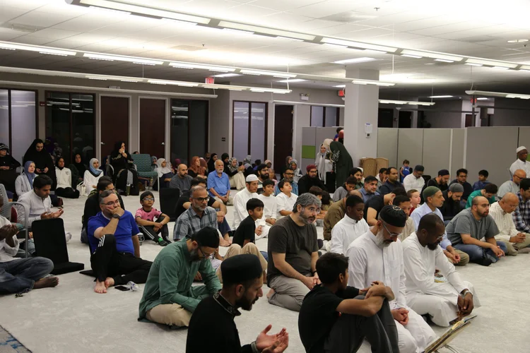 Community seated in the prayer hall